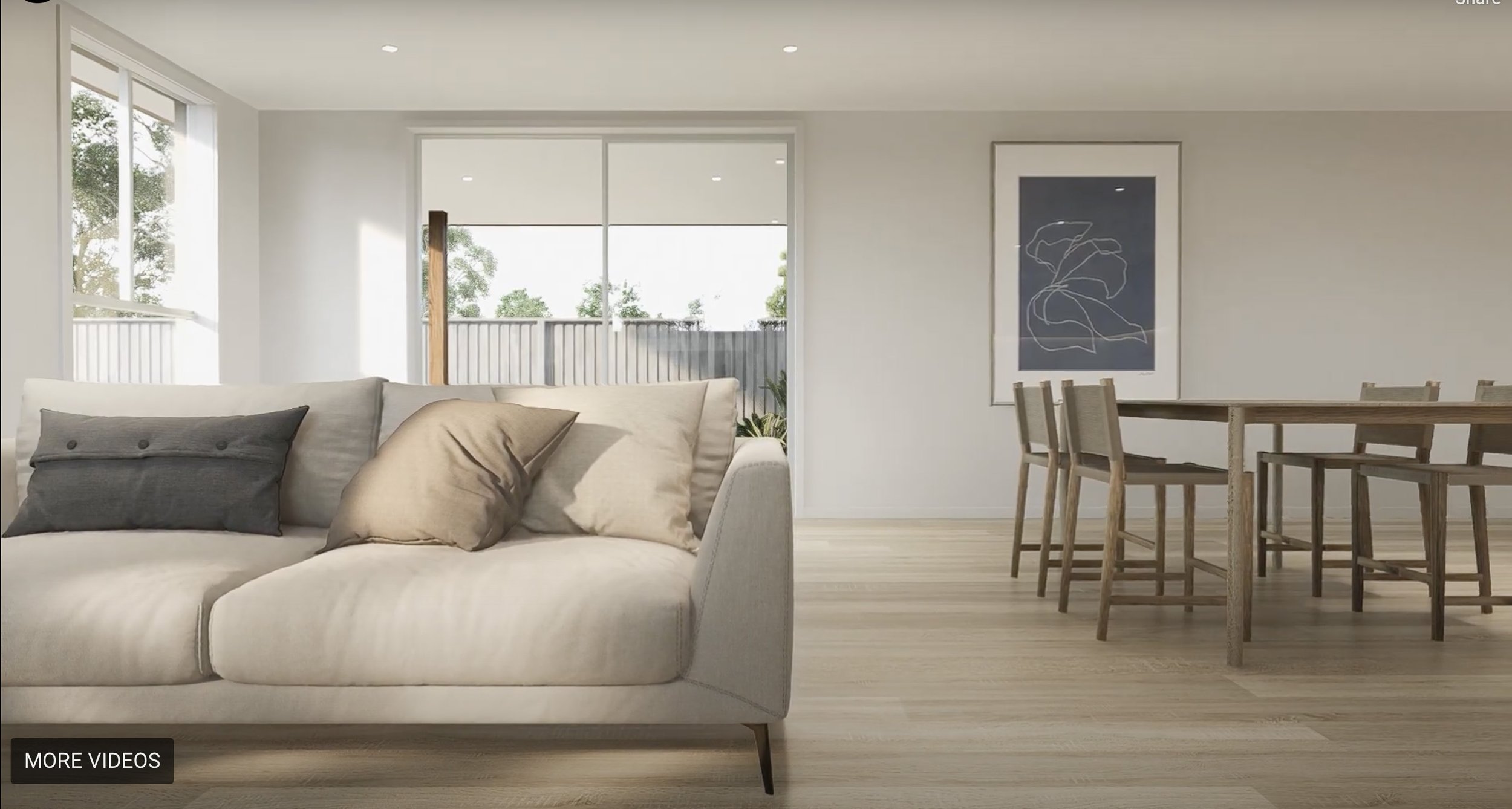 Modern living room with a beige sofa, pillows, large windows, a wooden dining table with six chairs, artwork on the wall, and a sliding glass door leading to a balcony with a railing and trees outside.