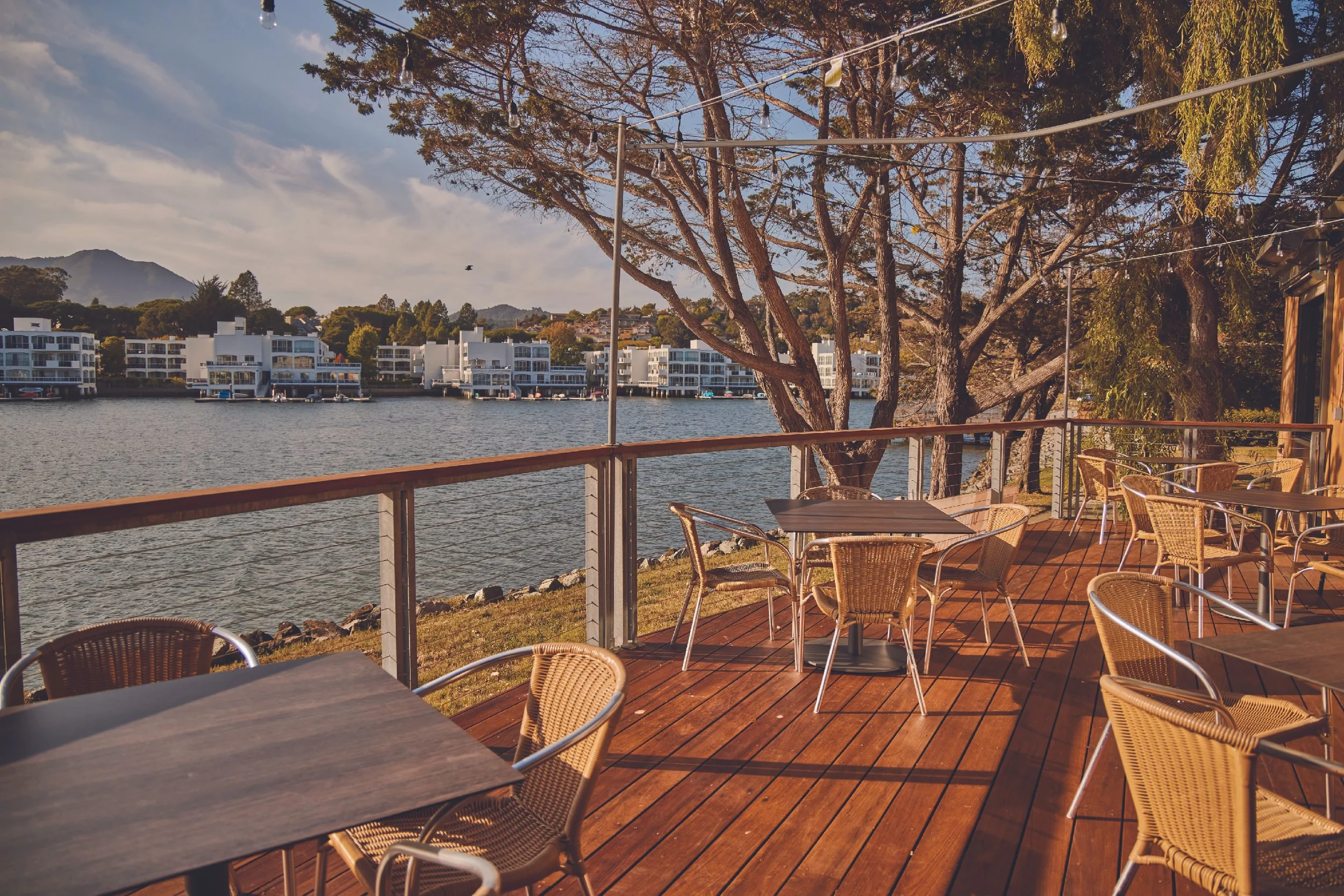 waterfront patio with tables and chairs