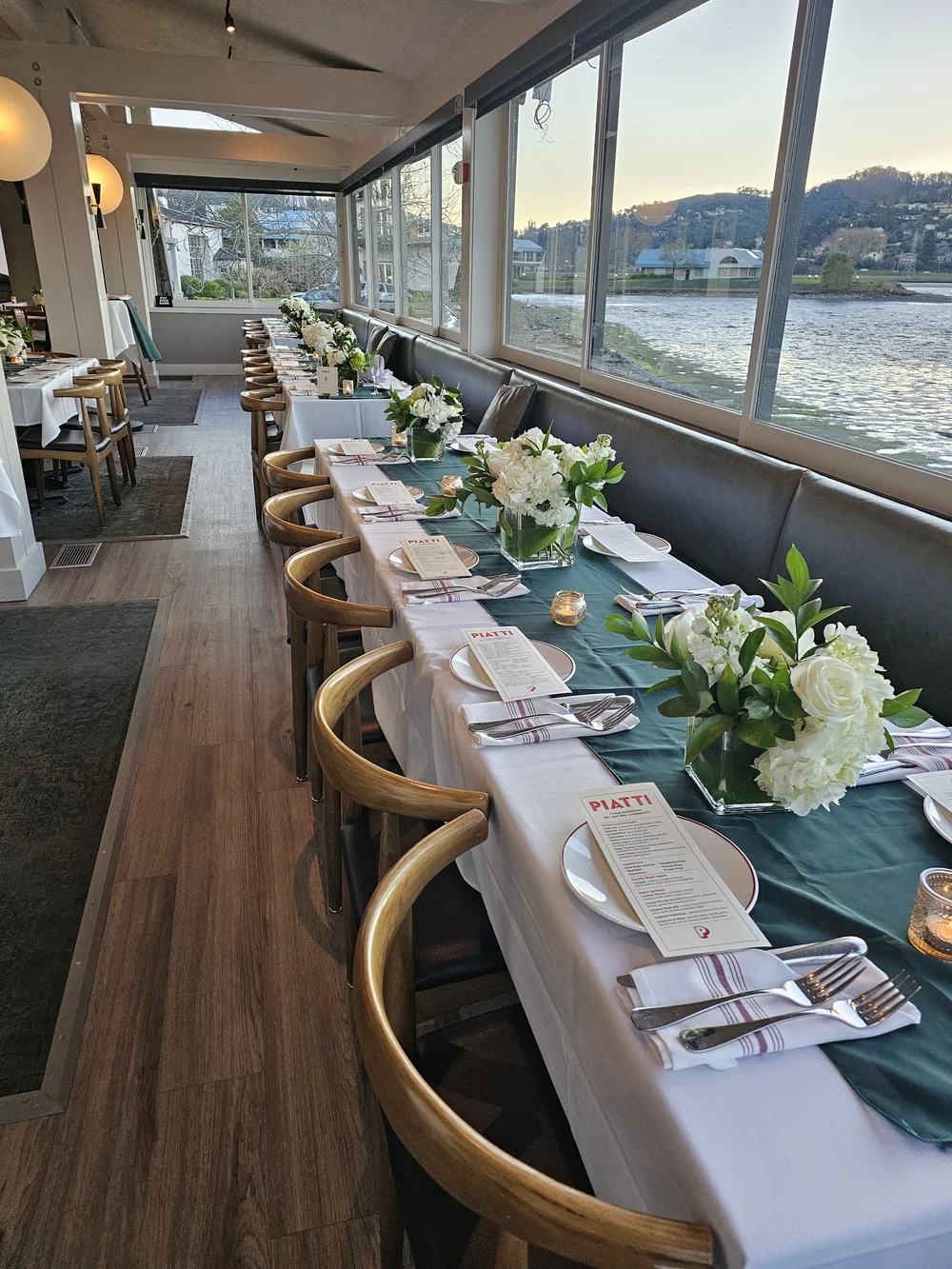 Main dining room at Piatti Mill Valley with water views through the windows