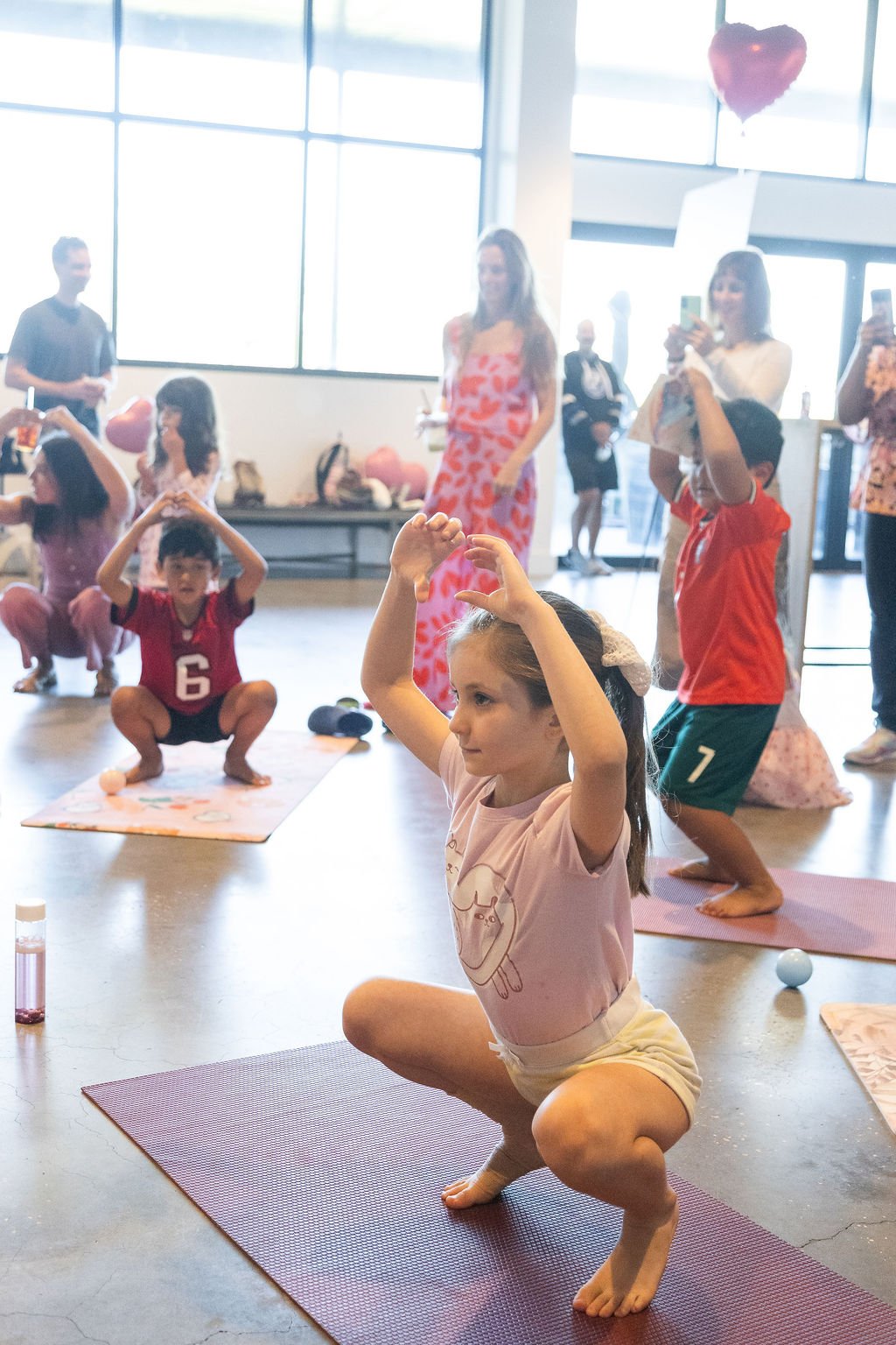 Kids playing yoga freeze dance at Young at Heart kids yoga event in South Tampa.