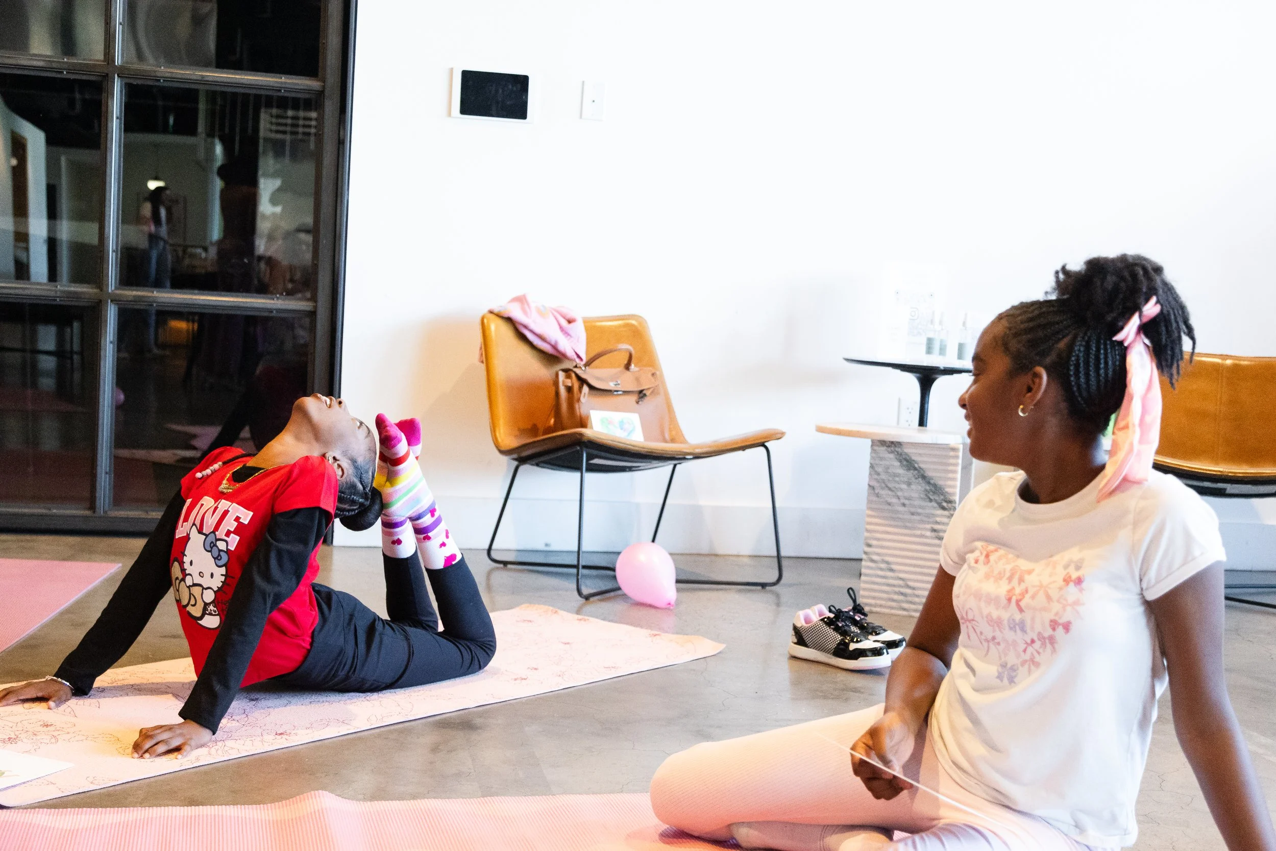 Kids connecting during yoga activity at Young at Heart's playdate