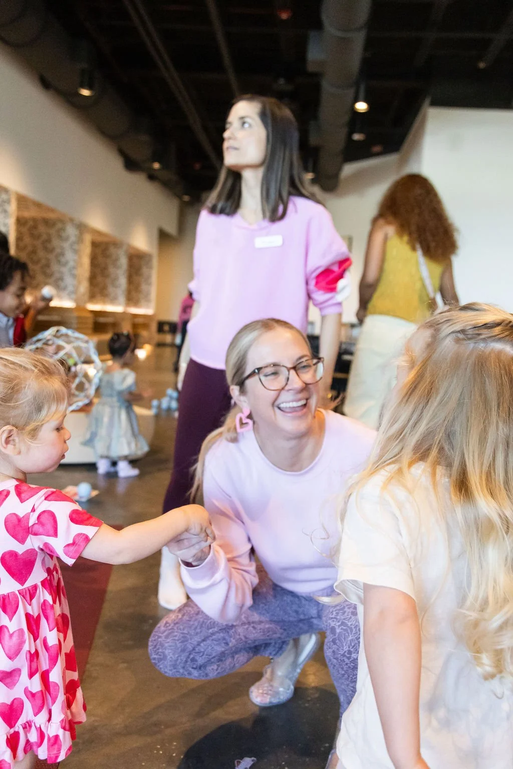 Parents and kids smiling at Young at Heart family yoga and craft playdate in Tampa