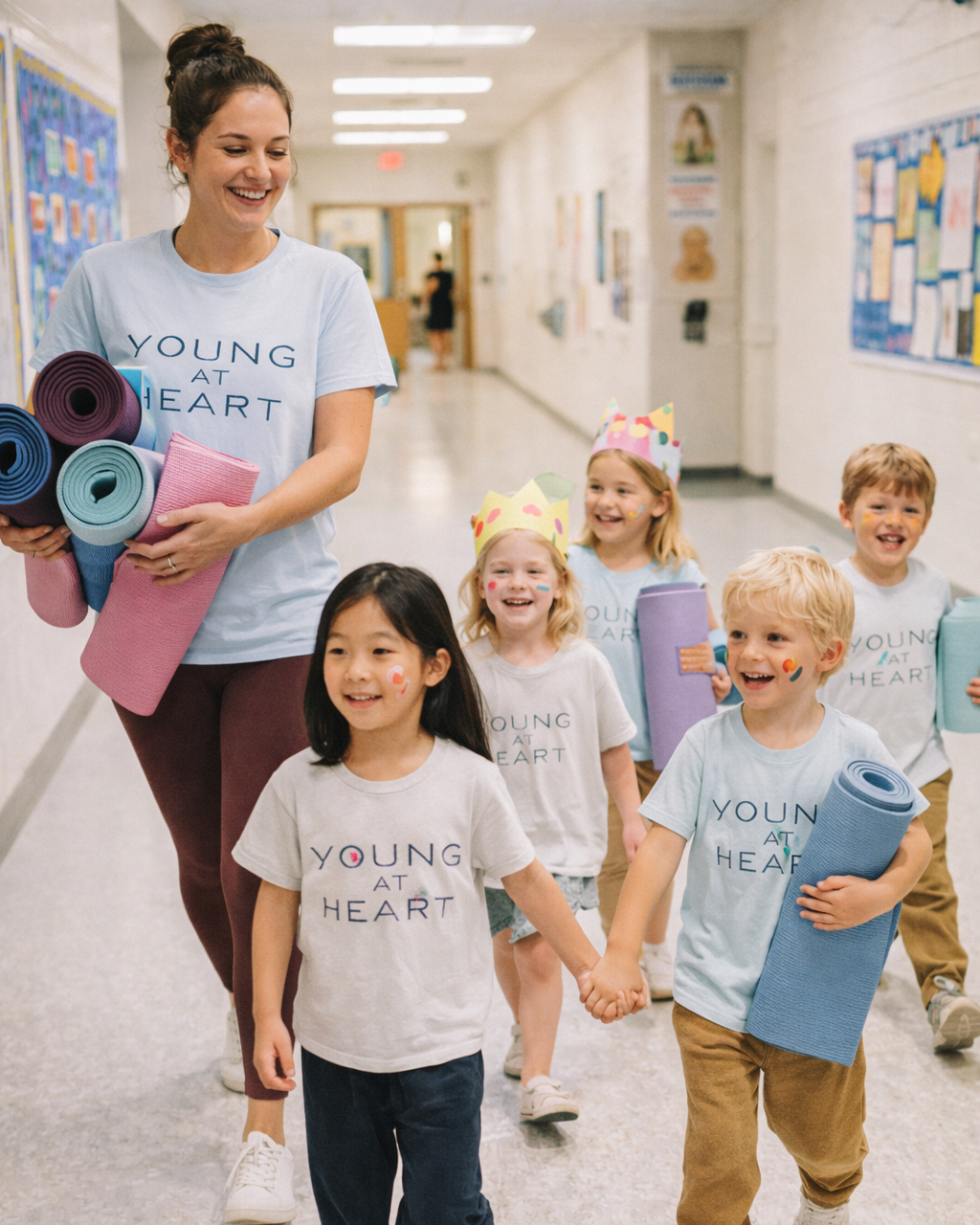 A group of kids lining up with their teacher walking to yoga class
