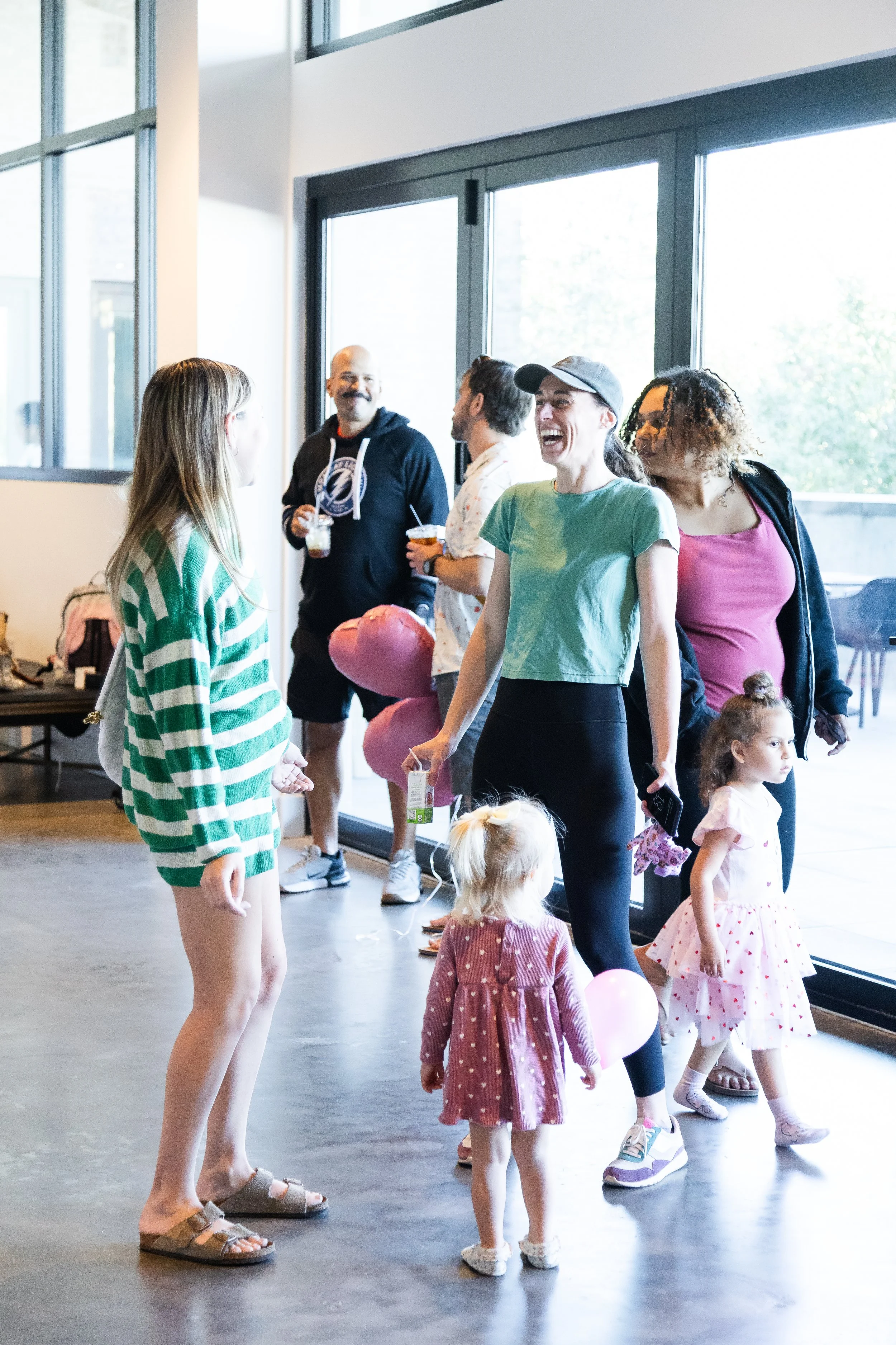 Community families connecting at Tampa kids yoga event.