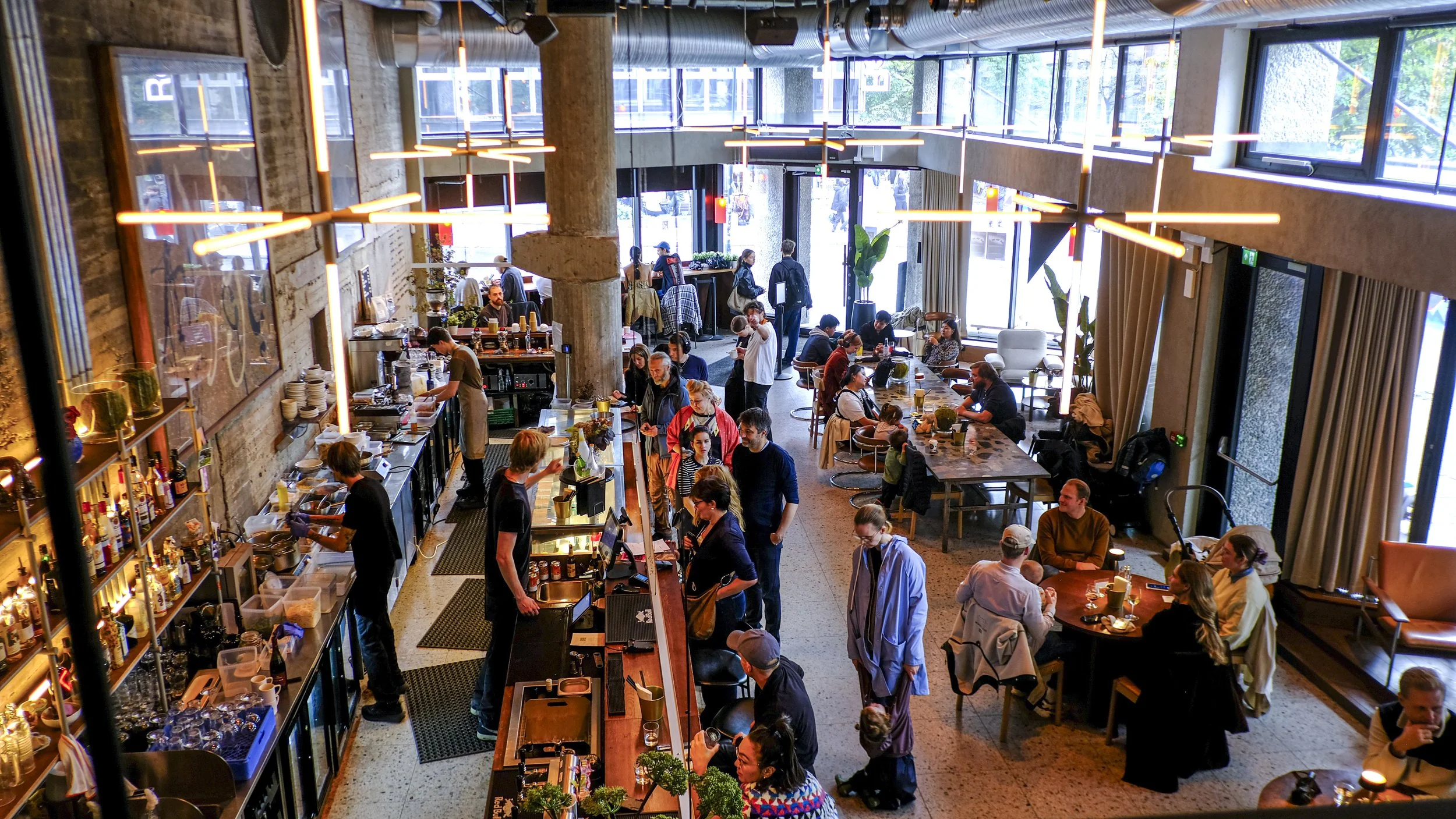 Folkeliv på Trekanten under Tullinfest – gjester som koser seg med mat og drikke i et pulserende café- og restaurantmiljø i Oslo sentrum.