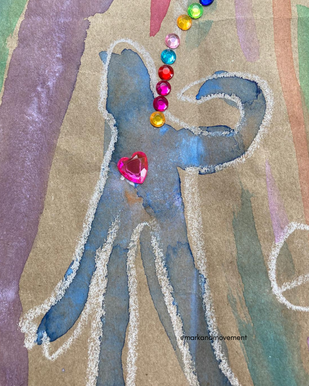 mixed media artwork of an abstract out line of a person with a pink gemstone heart with rainbow gems flowing out of it. watercolour, oil pastel on brown paper