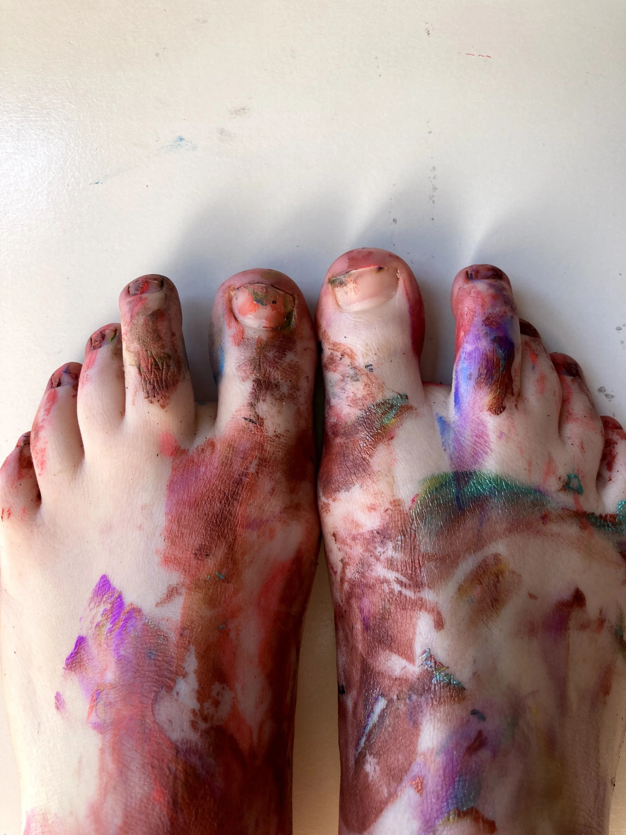 photograph of feet covered in colourful paint marks from a creative expression sessions