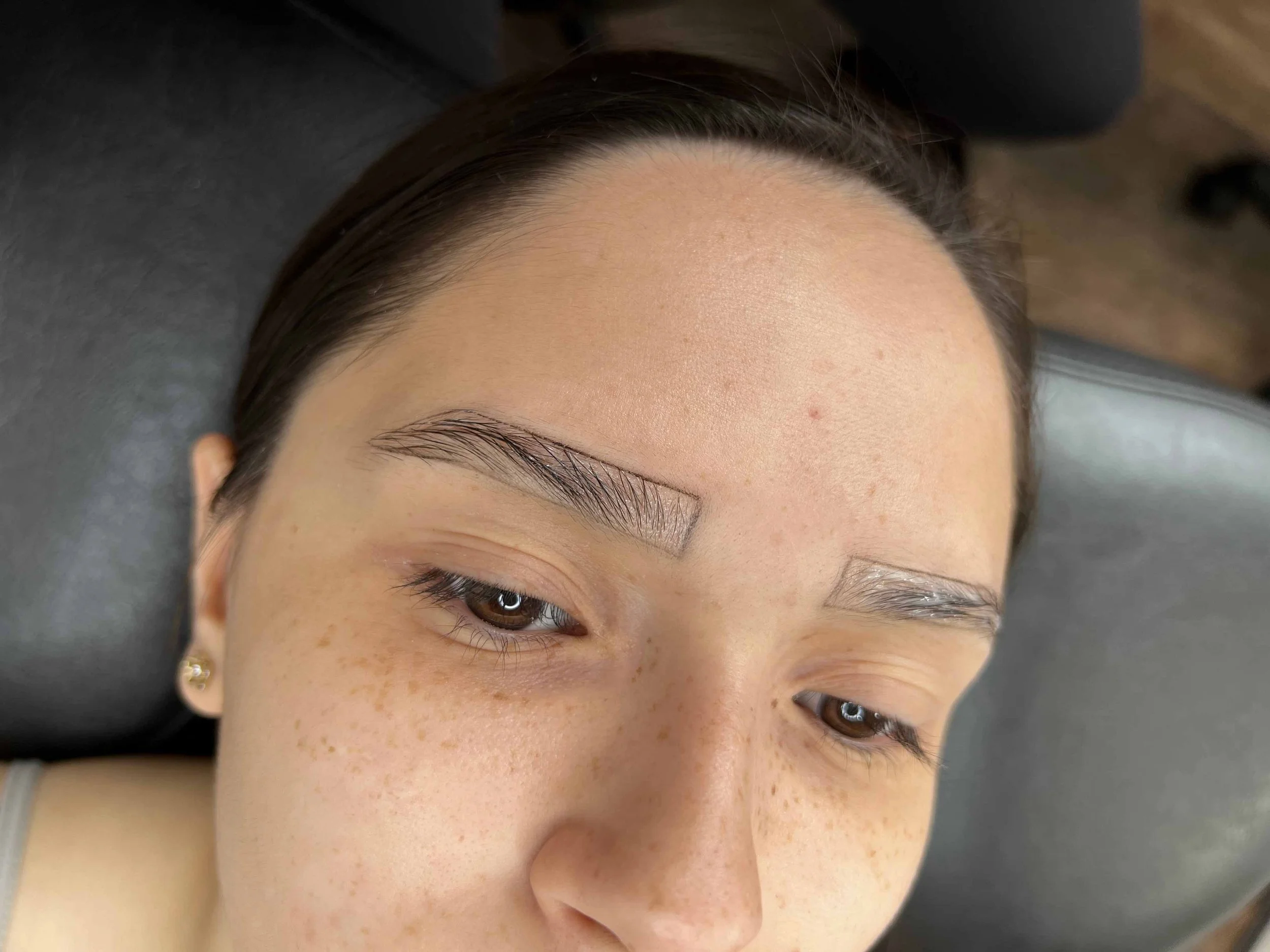 Close-up of eyebrows during microblading treatment with Lash Girl London