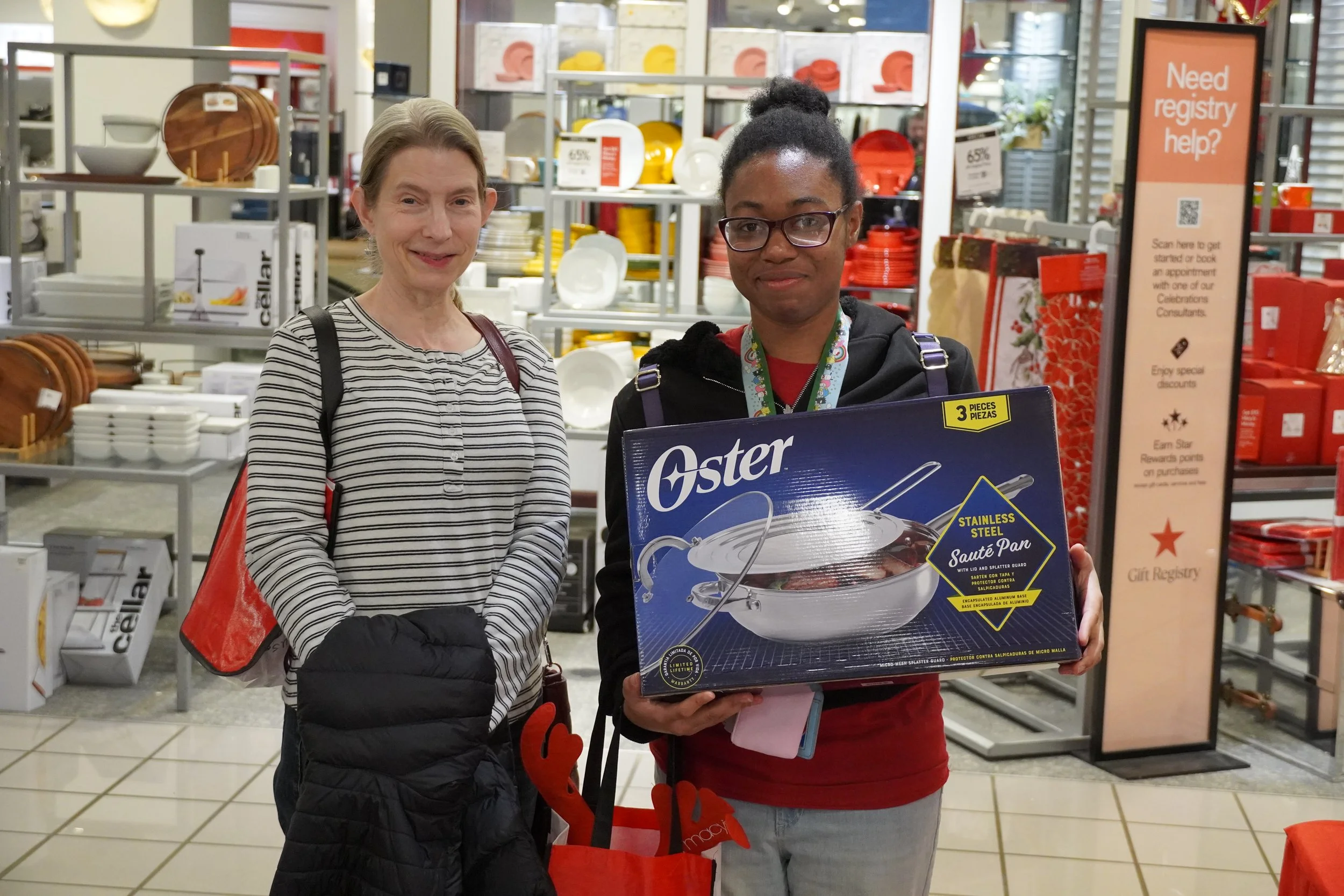  Big Sister Michelle, left, and Little Sister Antonia show off their Macy’s purchase. 