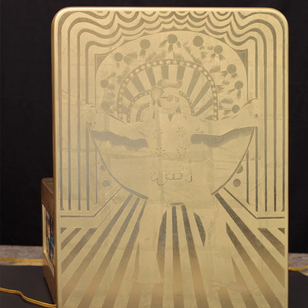 The backside of the display is fully leafed in 24ct gold and embossed with Elvis performing.