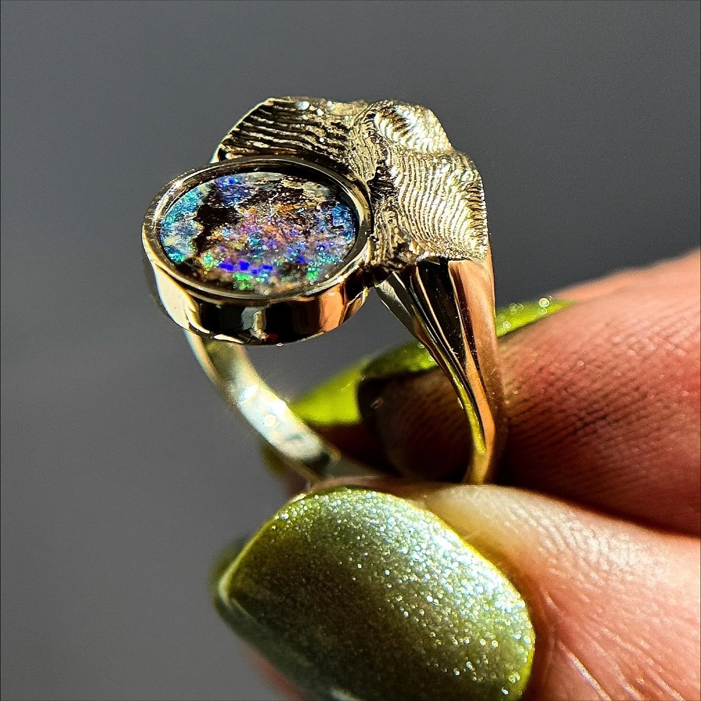 New custom topo+Cosmic Boulder Opal ✨💫

This ring felt like the perfect opportunity to show off my sparkly green nails 💚

This teeny tiny wearable mountain is made of 10k yellow gold, and showcases Mount Umunhum in California&rsquo;s Santa Cruz mou