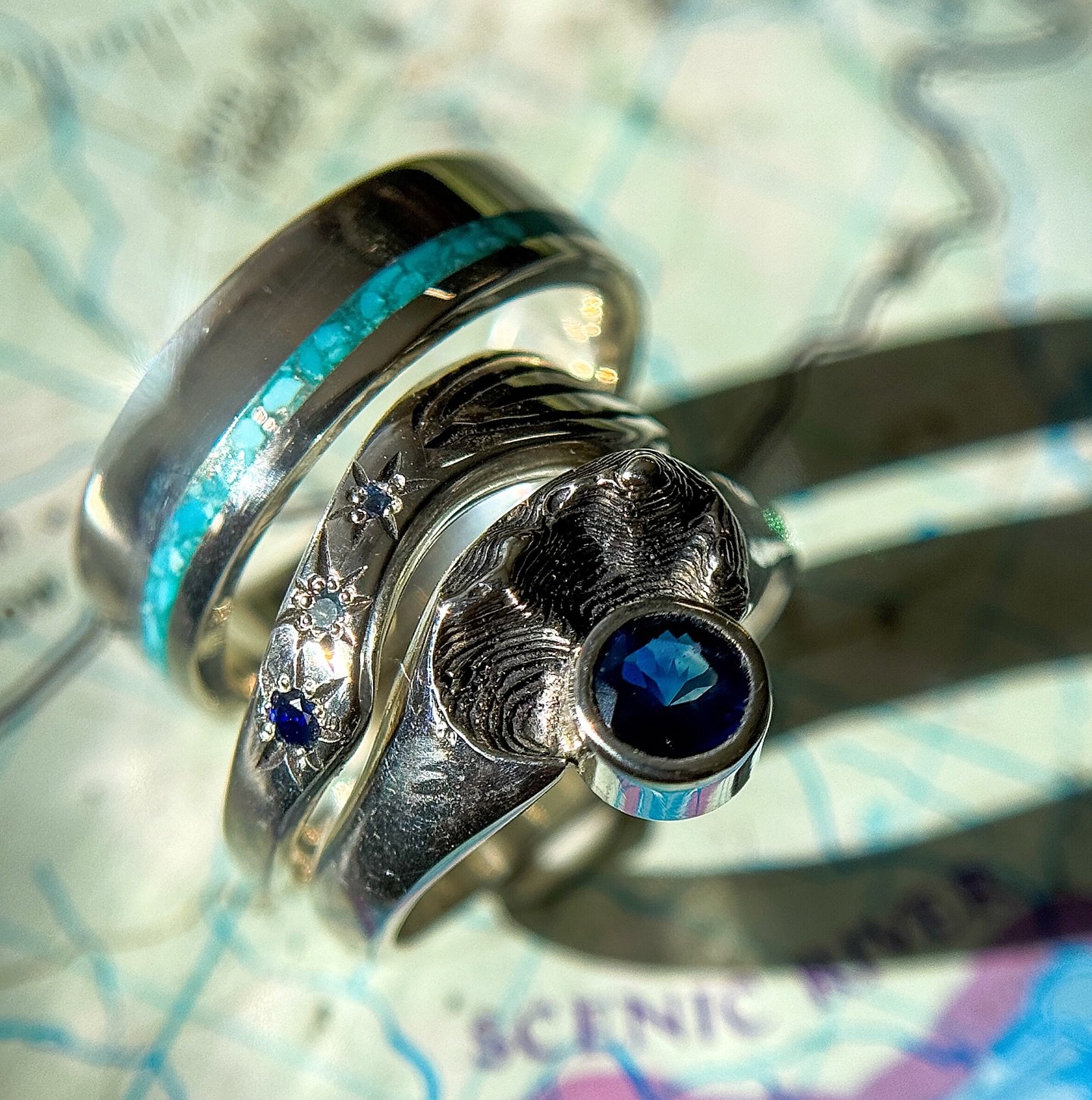 New custom set for Meghan + Davis 🩵🏔️

This sterling silver set takes us to the gorgeous state of Wyoming. Meghan&rsquo;s topo hug captures their favorite stretch of Tongue River Canyon, with a deep blue Montana sapphire nestled into the canyon wal