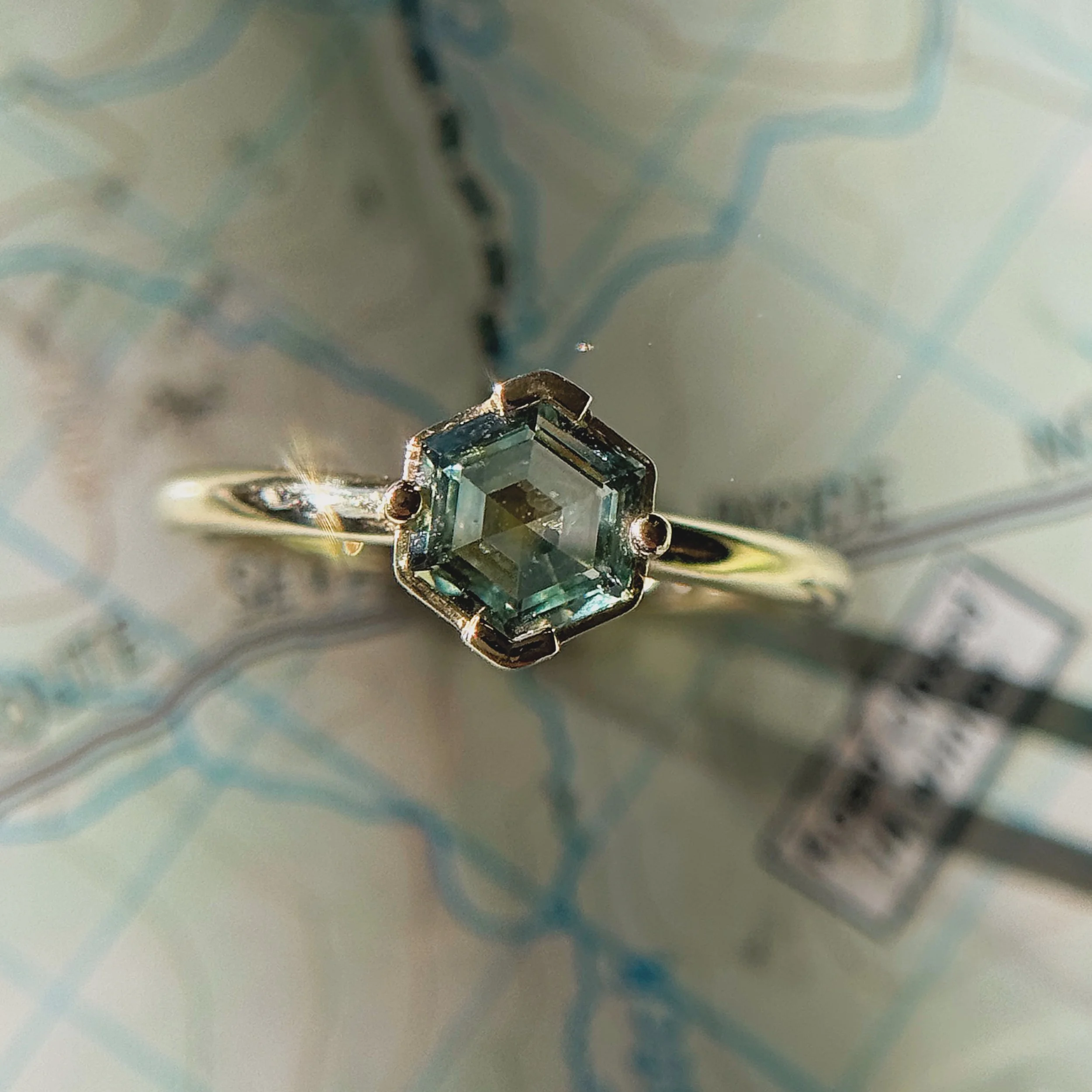 A moment with Due North # 5🏔️

A one of a kind, Montana Sapphire beauty. I immediately fell in love with its unique hexagon shape, and bi-color hues. It has that classic Montana teal hue, but if you look closely you&rsquo;ll see a flash of yellow in