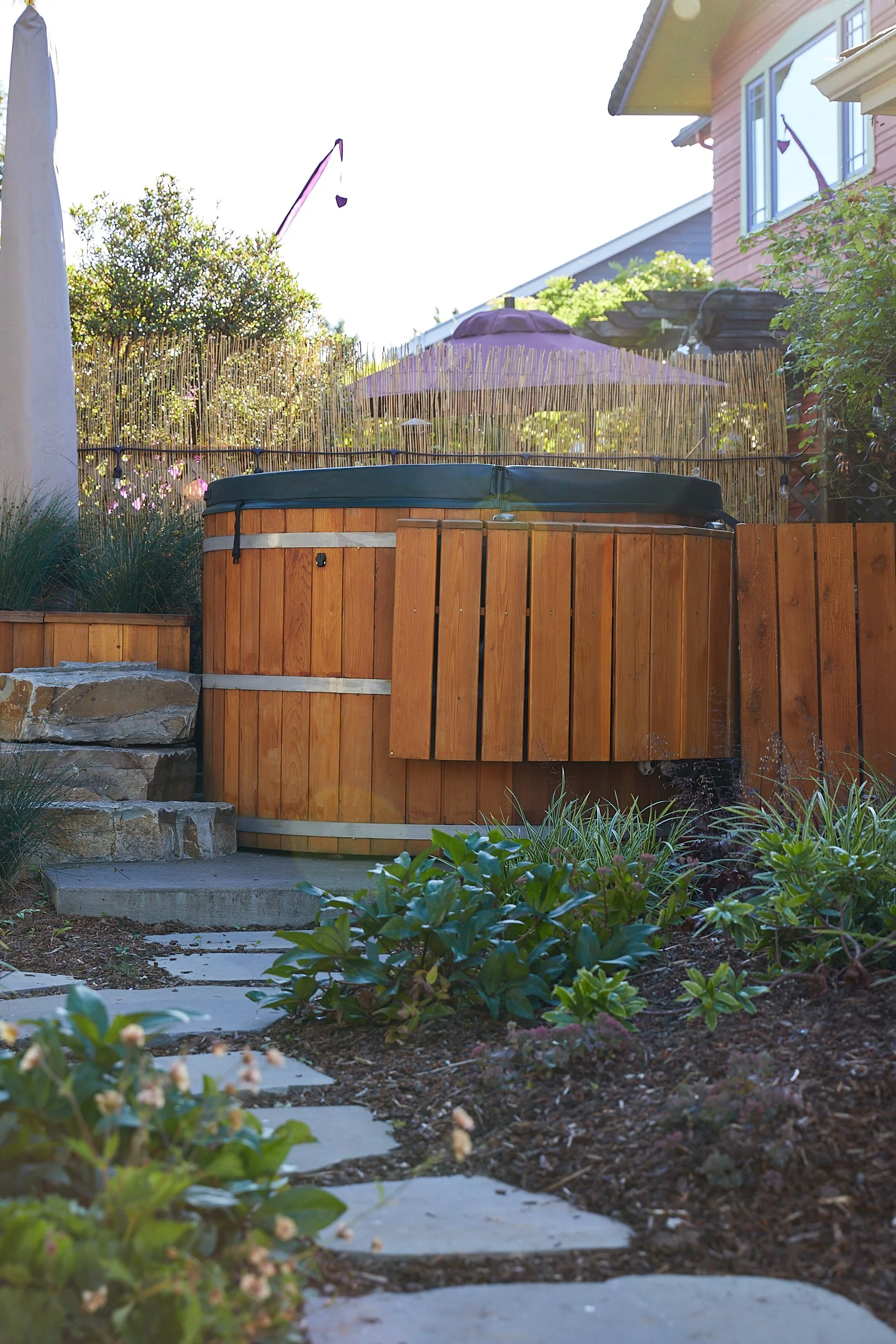 Cold plunge integrated into native plant landscape, Pacific Northwest wellness garden design