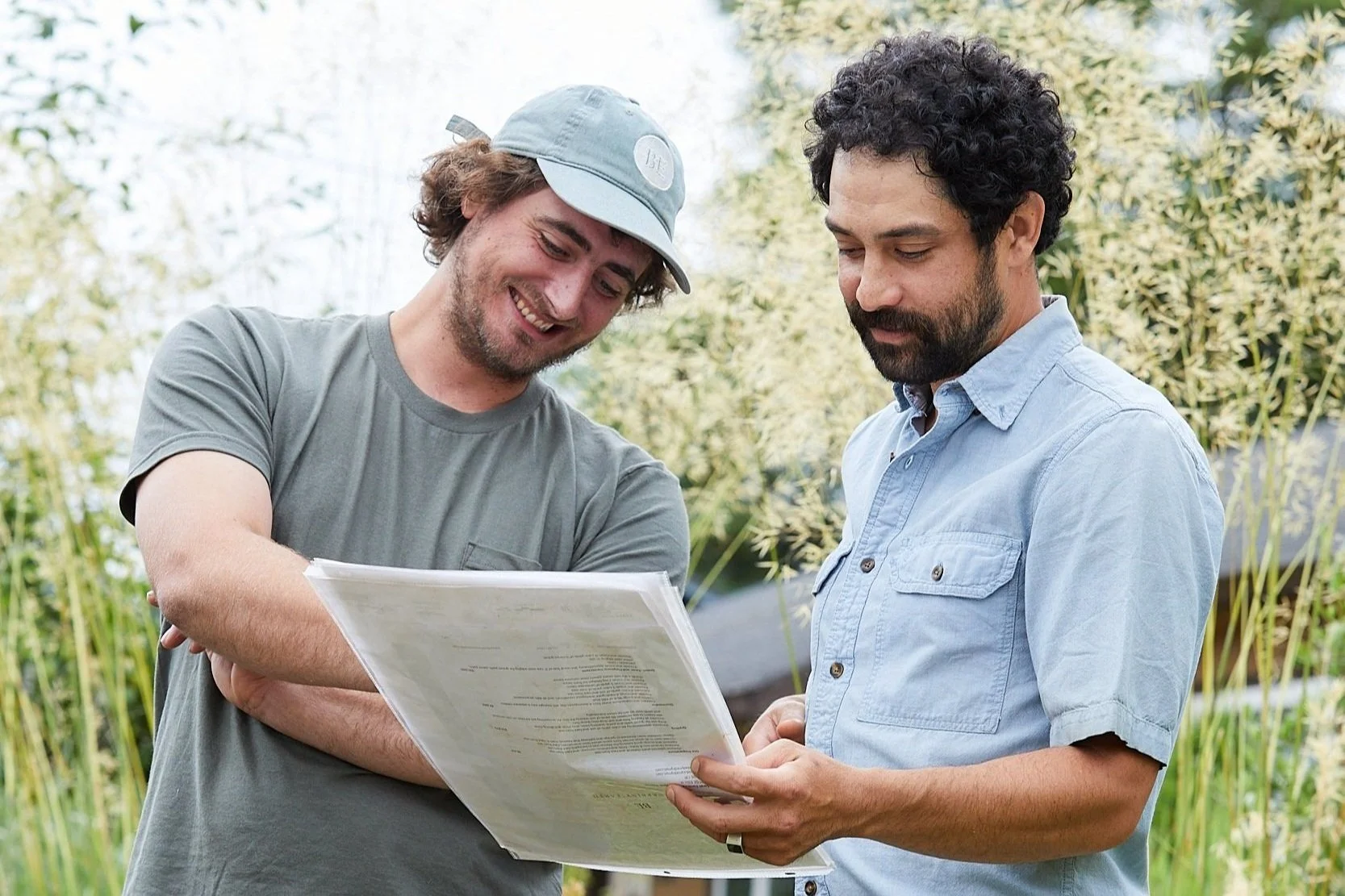 two landscape contractors reviewing a Blueprint Earth landscape design plan