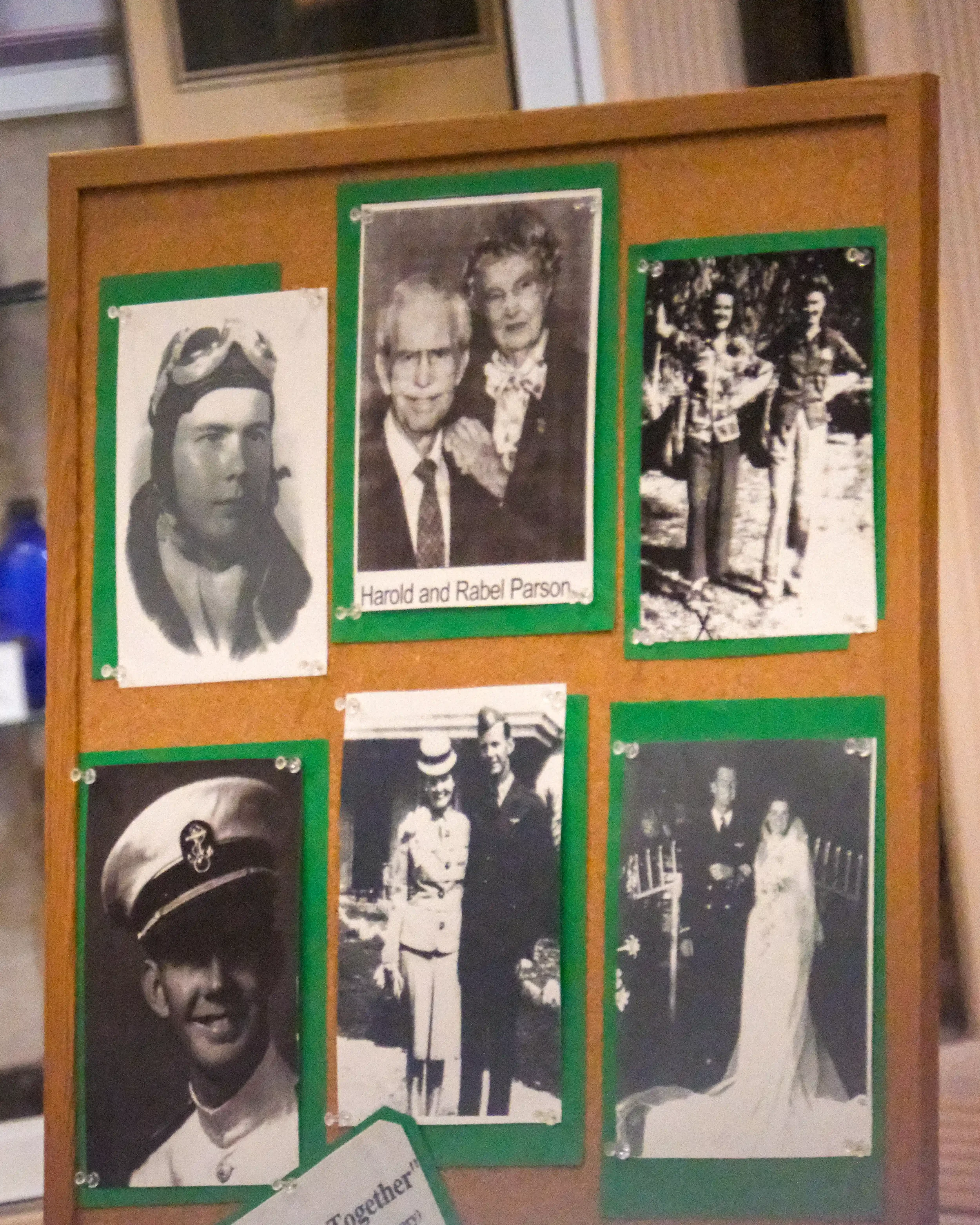 A presentation board featuring vintage black and white photographs charting the life of Harold and Rabel Parsons.