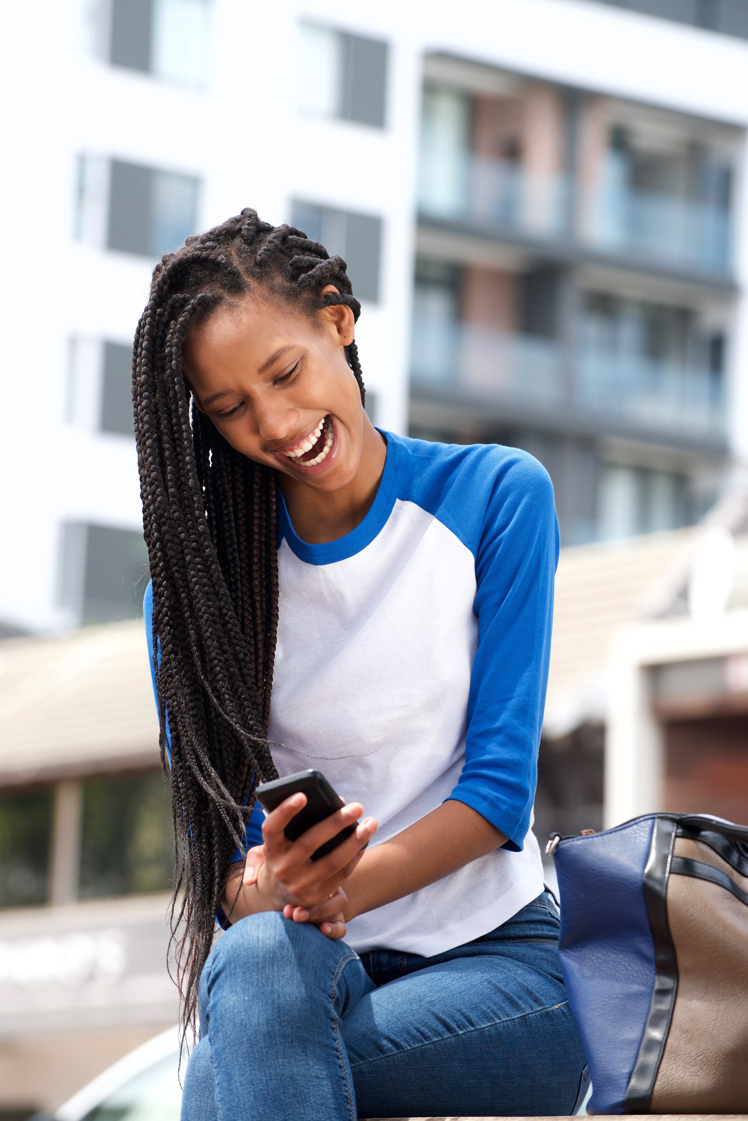 african-american-girl-reading-text-message-on-mobi-2022-02-02-03-57-15-utc.jpg
