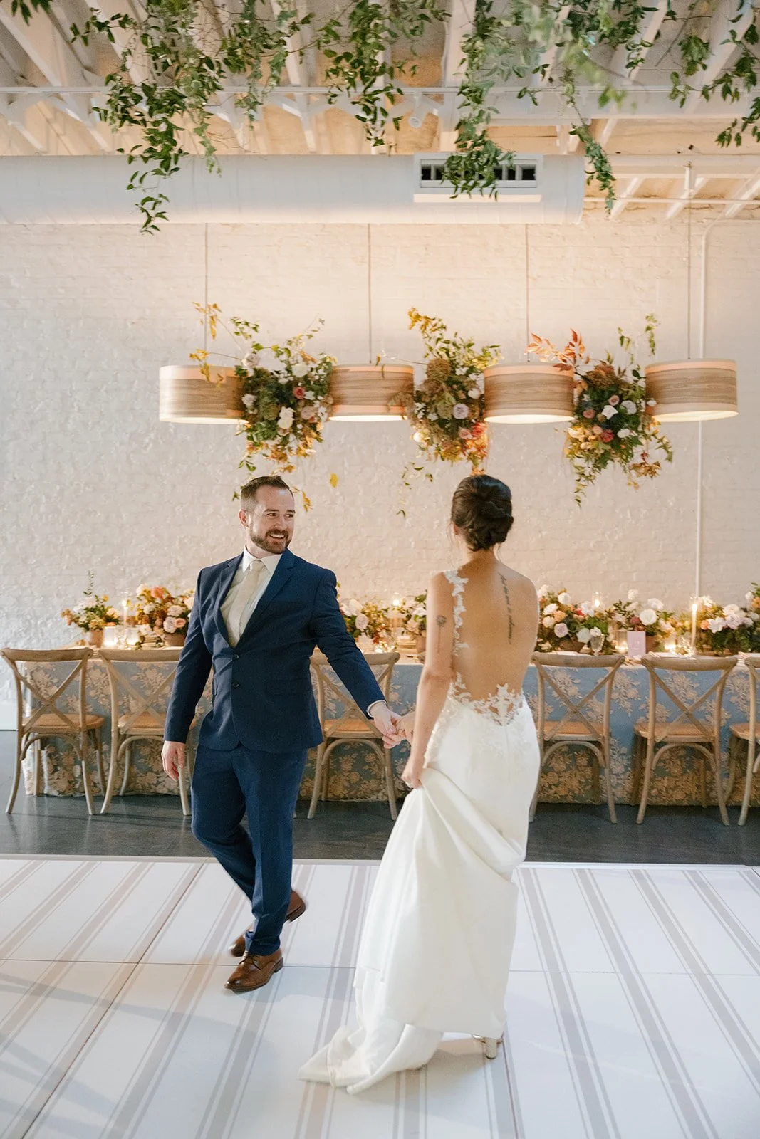 Lovely couple graces the luxurious ambiance of their wedding reception. Custom dance floor