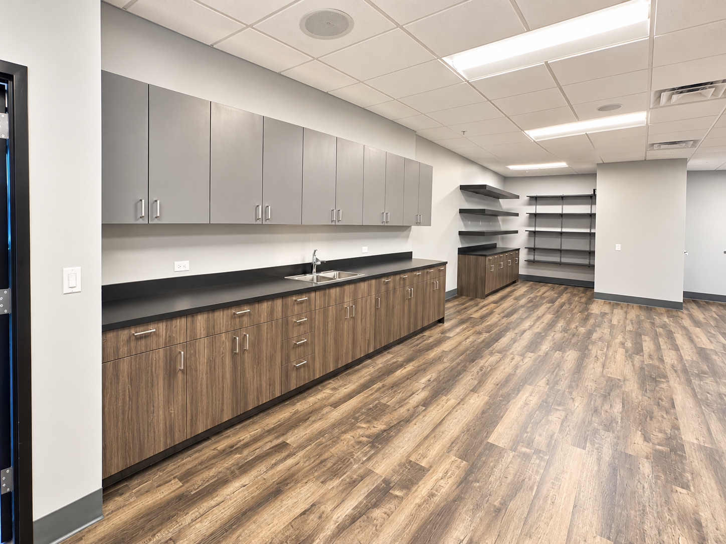 Modern Office Breakroom with Woodgrain Cabinetry.png