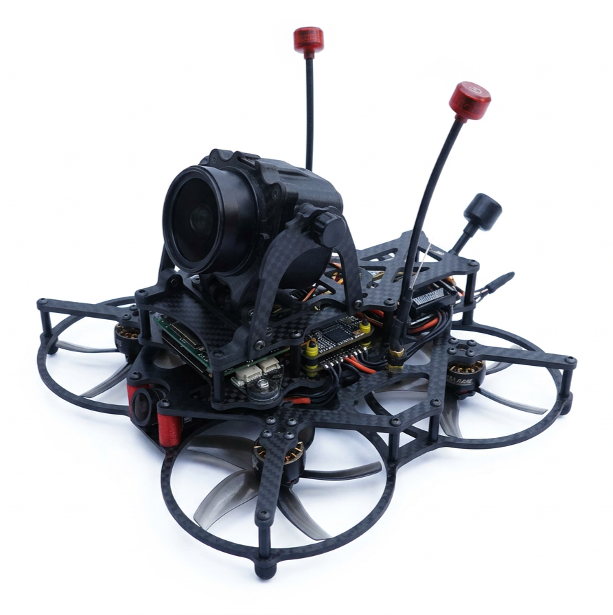 A racing drone with a camera mounted on top, four propellers, and antennae, built with a black carbon fiber frame, on a white background.