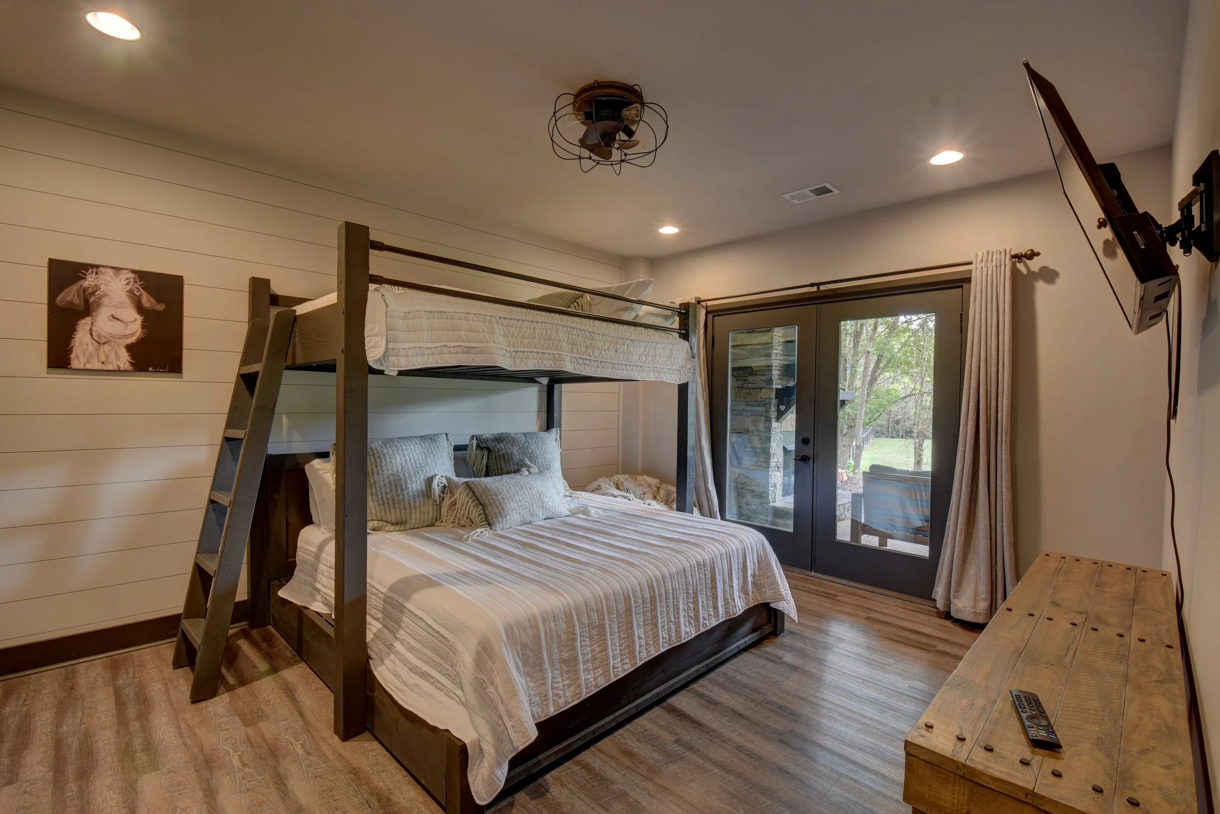 The bunk room with our custom made full XL over king bunk bed fitted with 12" thick hybrid memory foam mattresses is by far the favorite hang out location for the kids. Watch movies or play games on the wall mounted TV.  Blackout curtains keep the ki