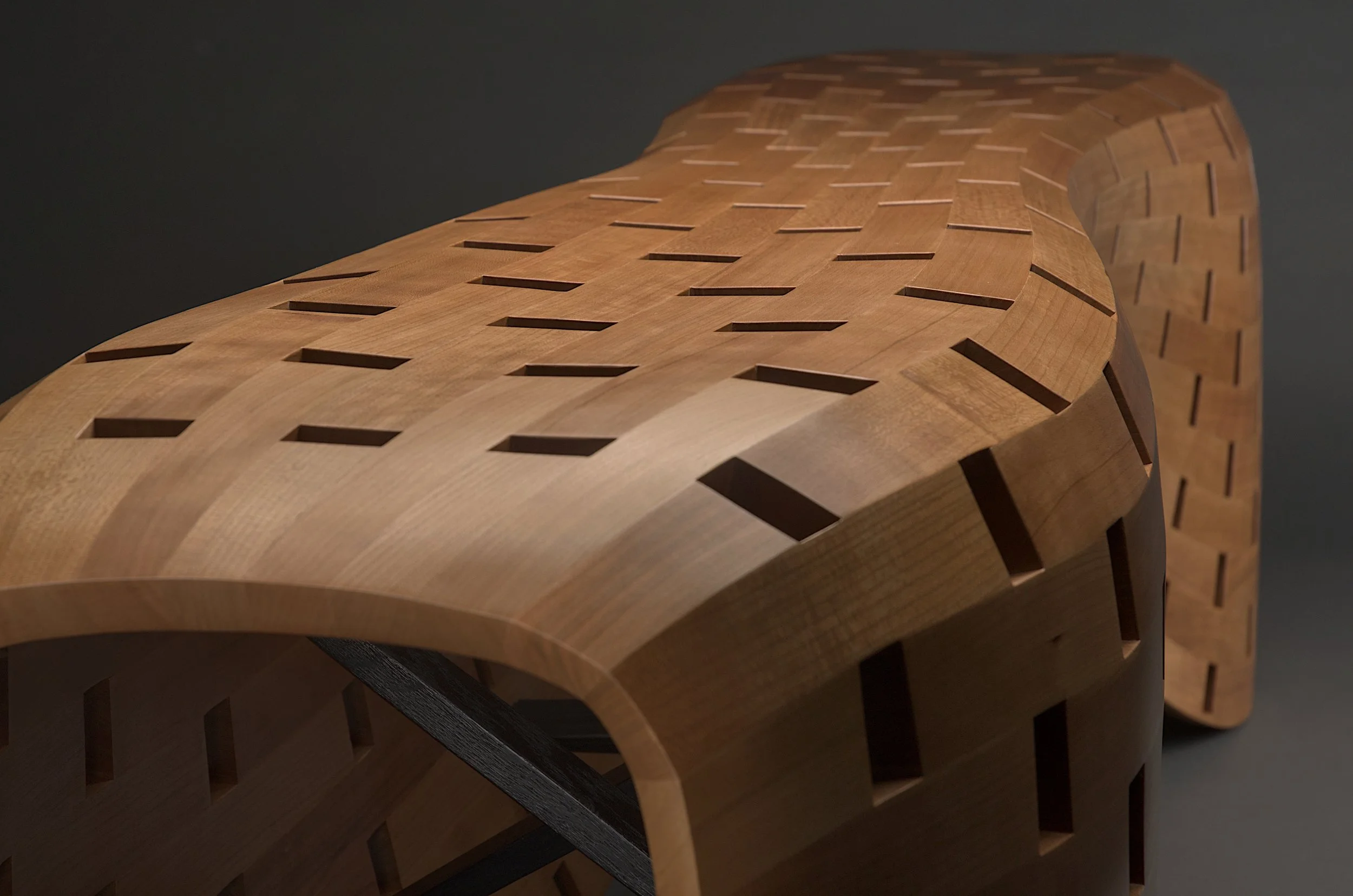 Detail view of end of Peanut Bench also showing curves in background