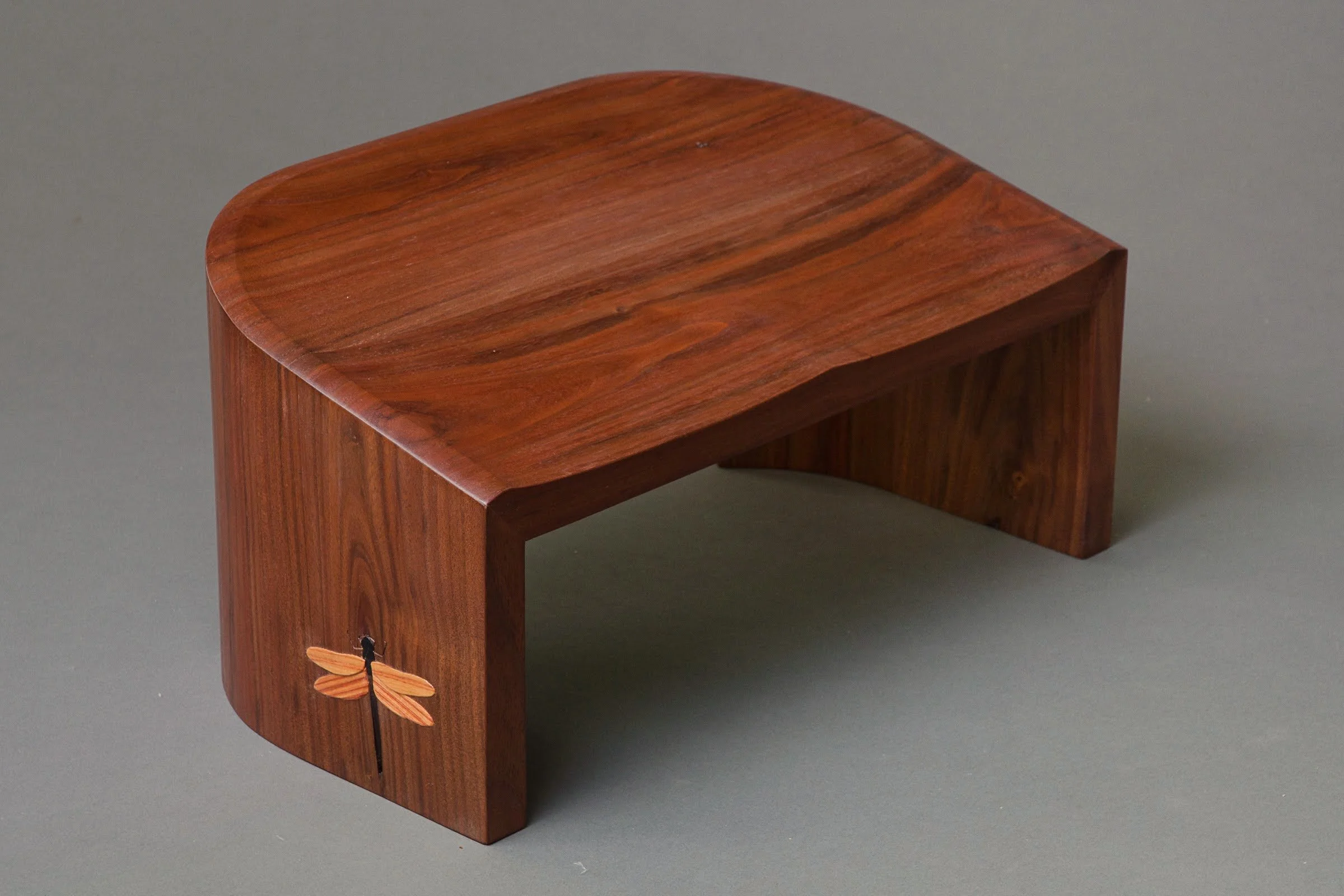 Dragonfly Kneeling Stool, three-quarter view from front with carving visible