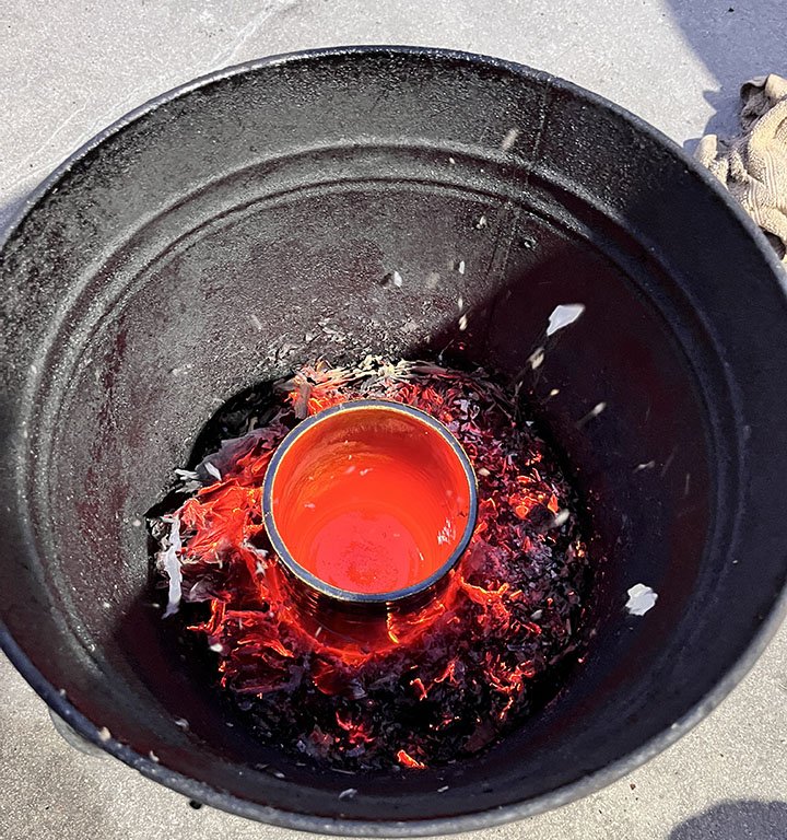 Glowing Red Vase in Trash Can