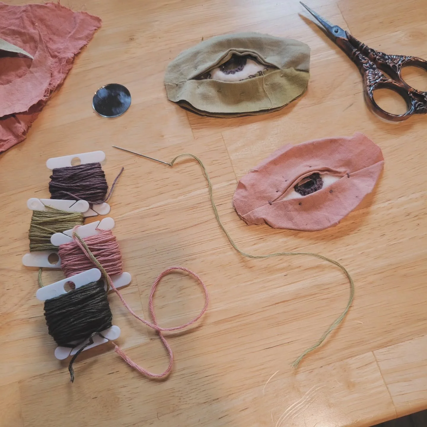 I've officially finished dyeing my fabric and embroidery floss for this body of work, and now I get to experiment with the color palette directly. Late at night, I end up constructing these eye forms just so I have something small to keep my hands bu
