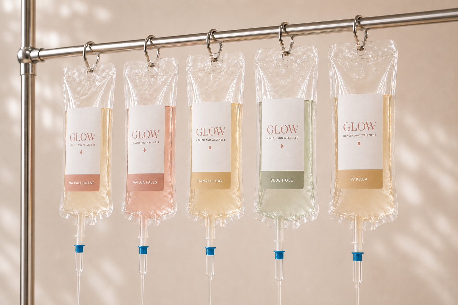 Five custom IV vitamin therapy bags from Glow Health and Wellness displayed on an IV stand