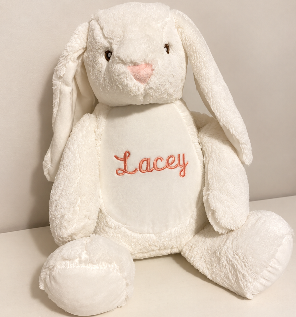 Personalised white embroidered bunny with the name Lacey in pink thread