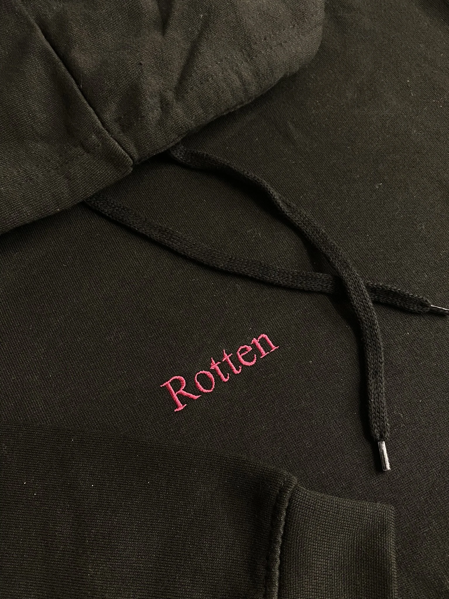 Black Rotten Hoodie with pink embroidered Rotten lettering