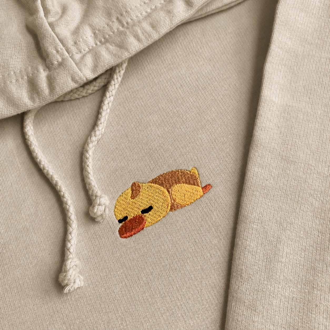 Stone close-up Sleepy Duck Embroidery – Stone Duck Hoodie Close Up Light blue hoodie