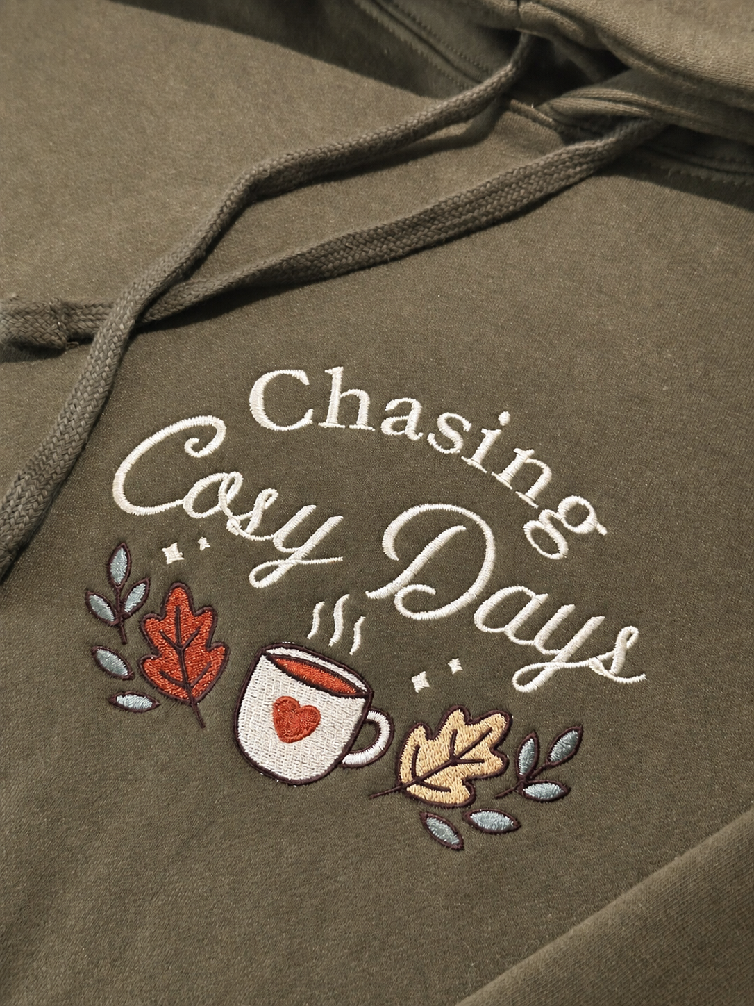 Close-up of Chasing Cosy Days autumn embroidery with cosy mug and leaves (Copy)