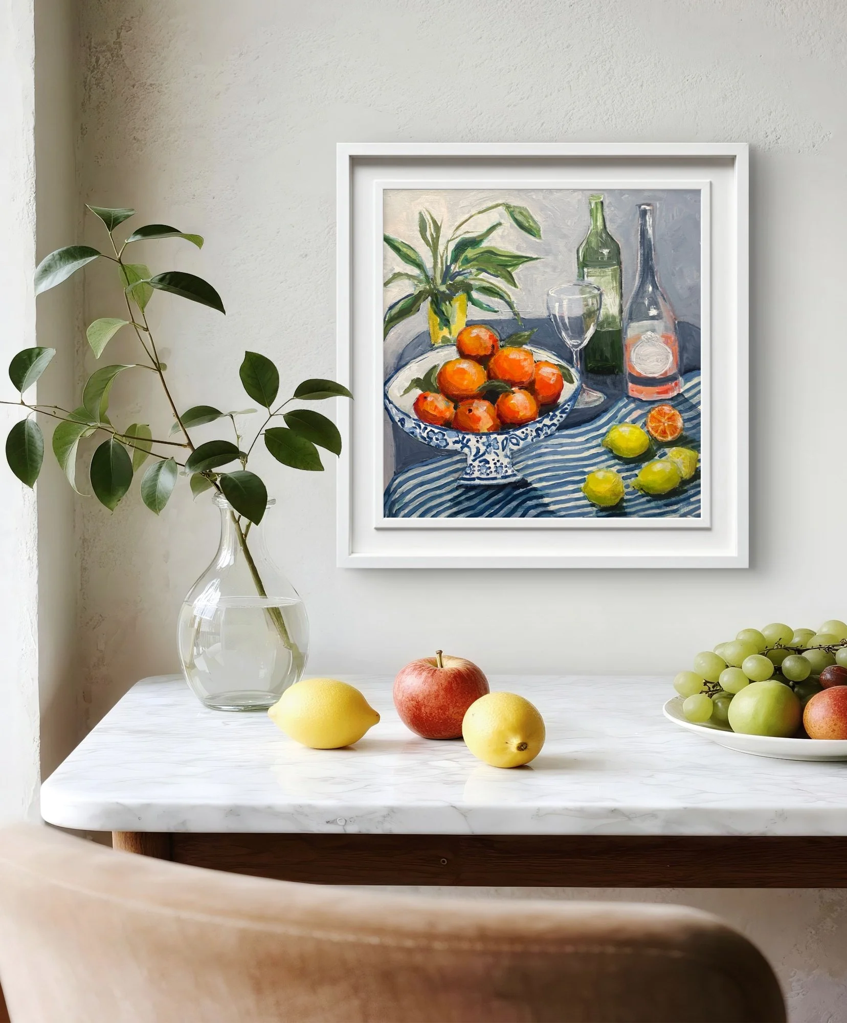 A still life painting of oranges in a blue patterned bowl, with lemons and wine, photographed in a home setting