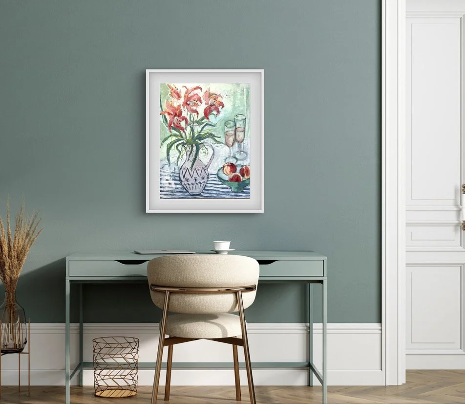 An elegant floral still life painting shown hanging above a pretty home deskdesk
