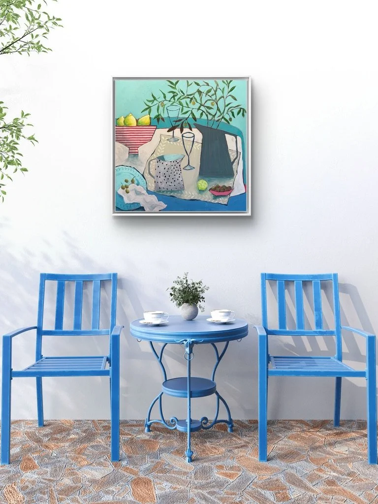 a modern still life painting in turquoise and pink, hanging on a wall above a blue table and chairs