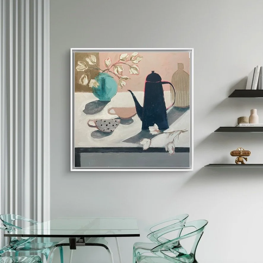 An original still life painting on the wall of a dining room, with coffee pot, cups and a vase of flowers