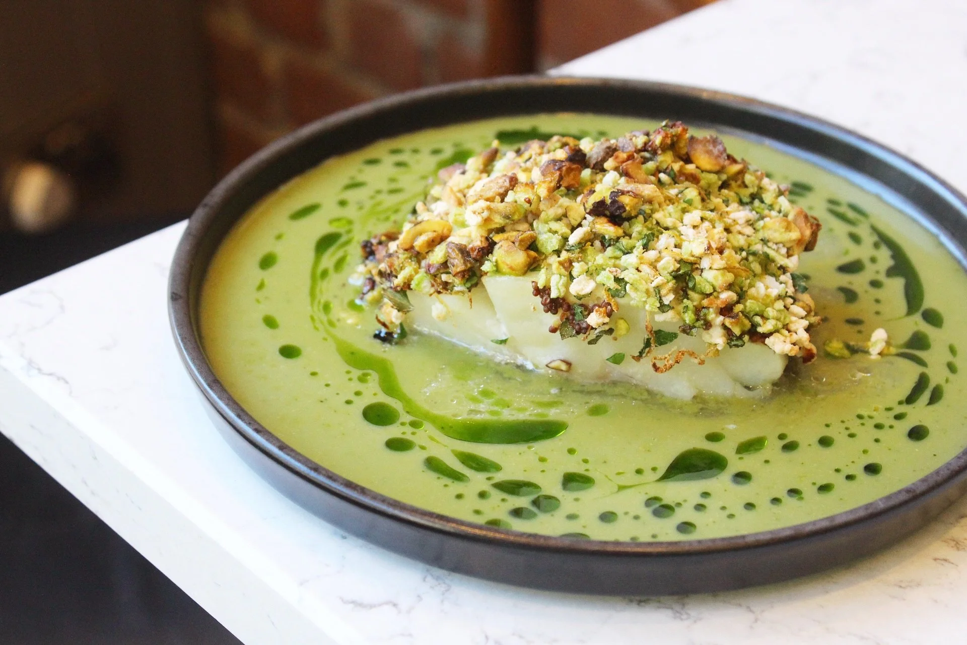 Pistachio crusted cod loin, corn lime dressing, early harvest olive oil 🐟 💚