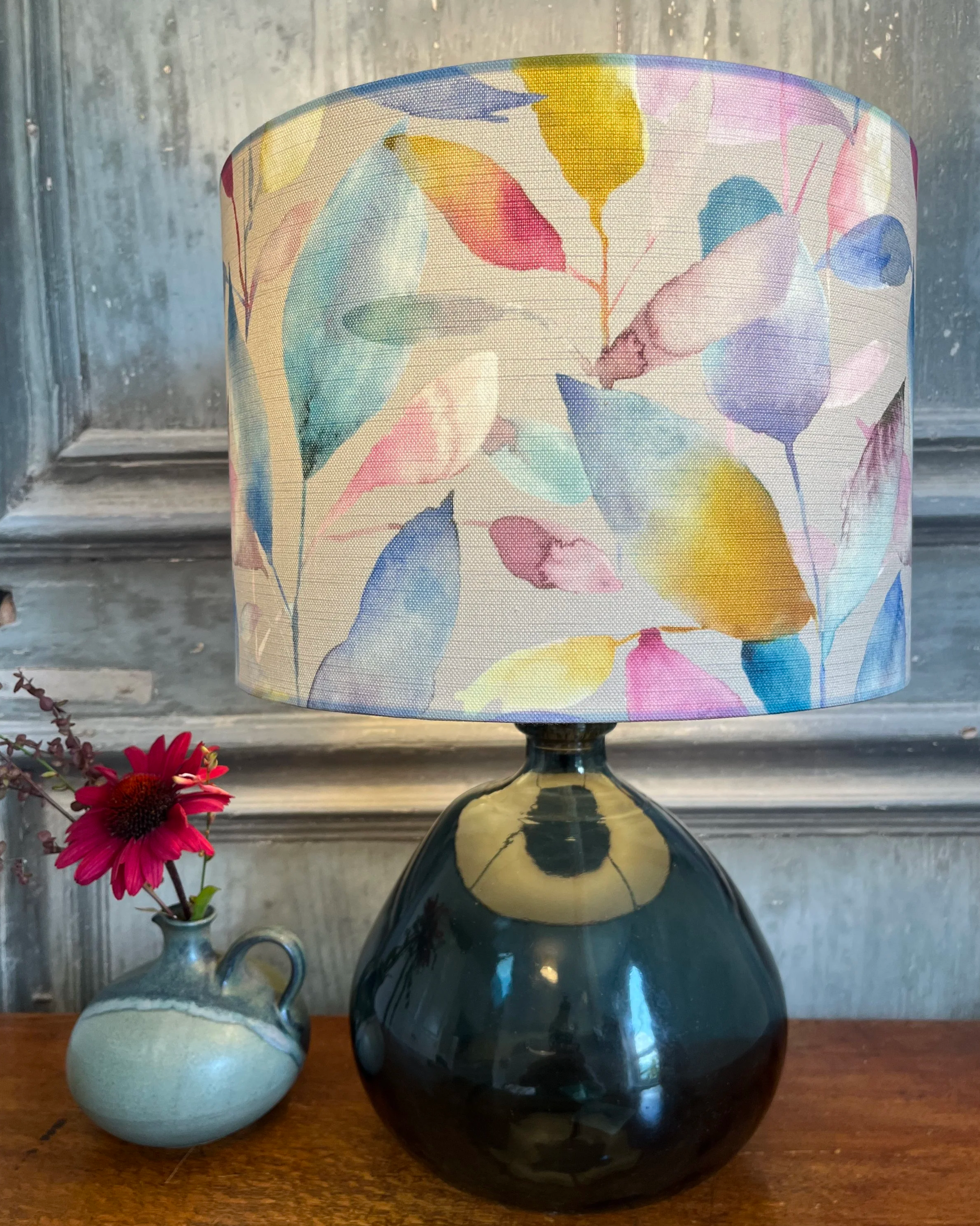 Drum lampshade made with multicolour leaf design with watercolour effect.