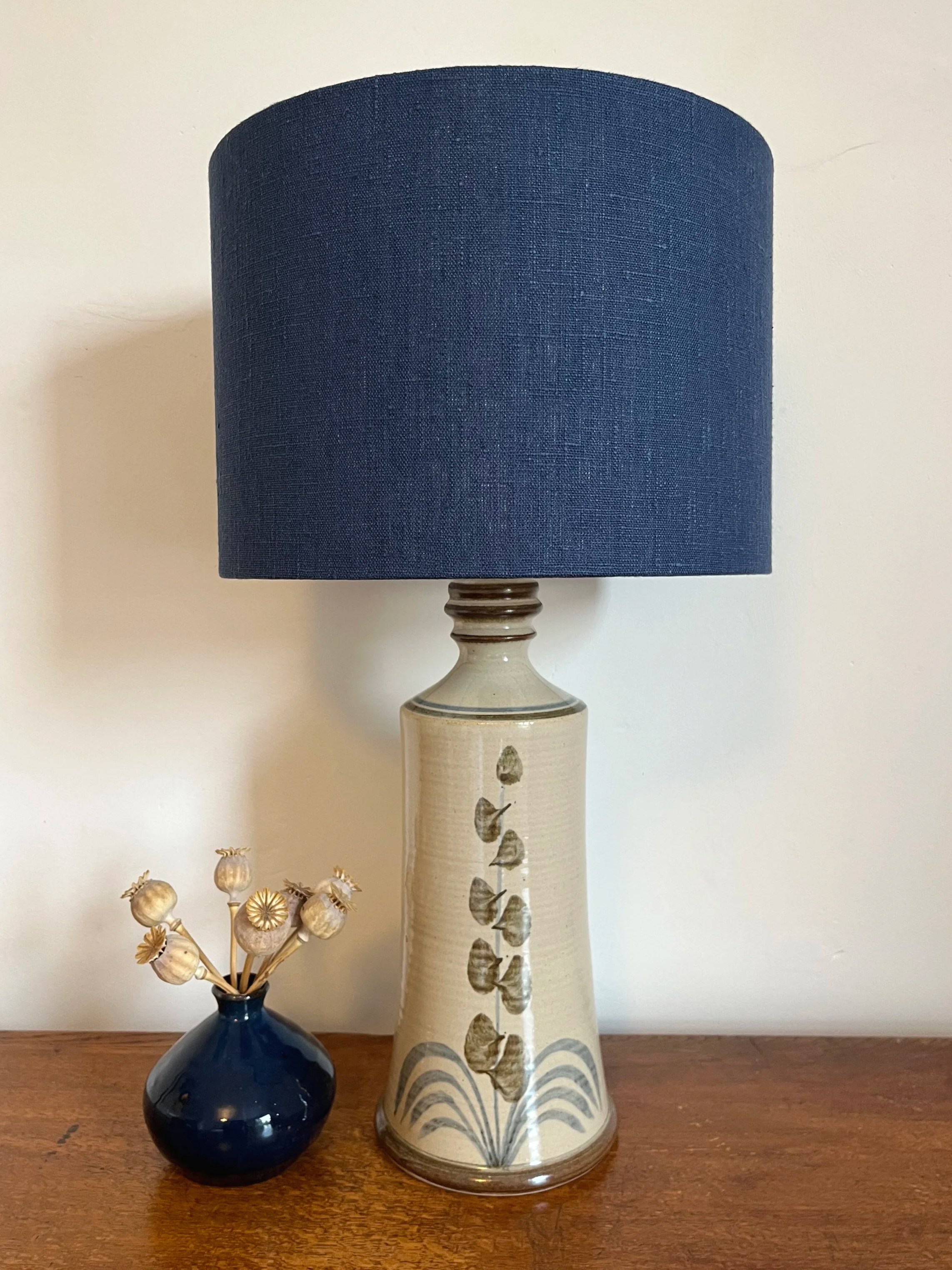 Navy linen drum lamp shade on ceramic lamp