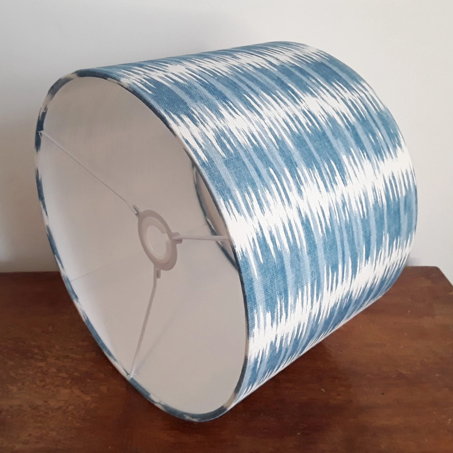 aqua blue and white striped lamp shade with white lining.