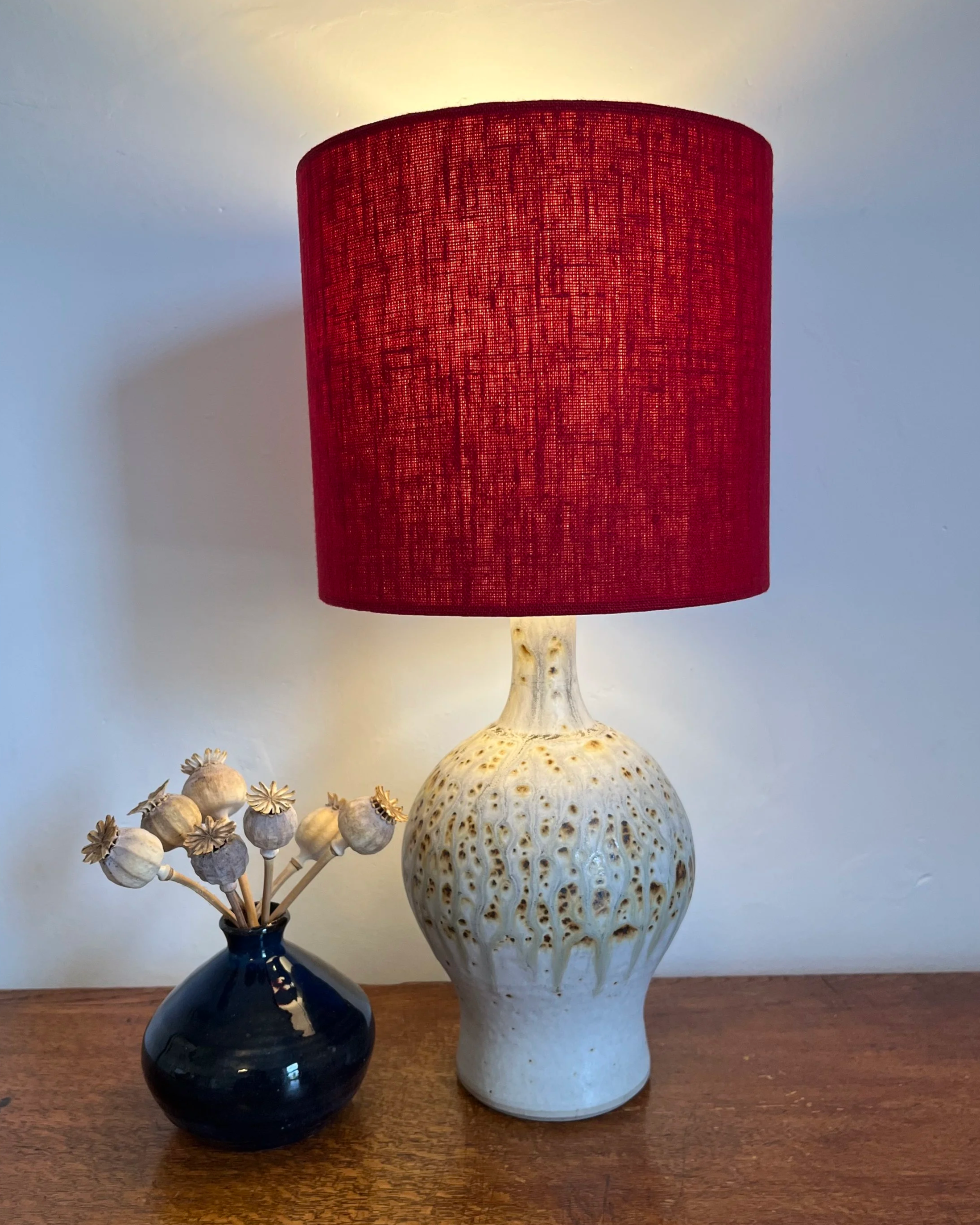 Scarlet red linen lamp shade, illuminated.