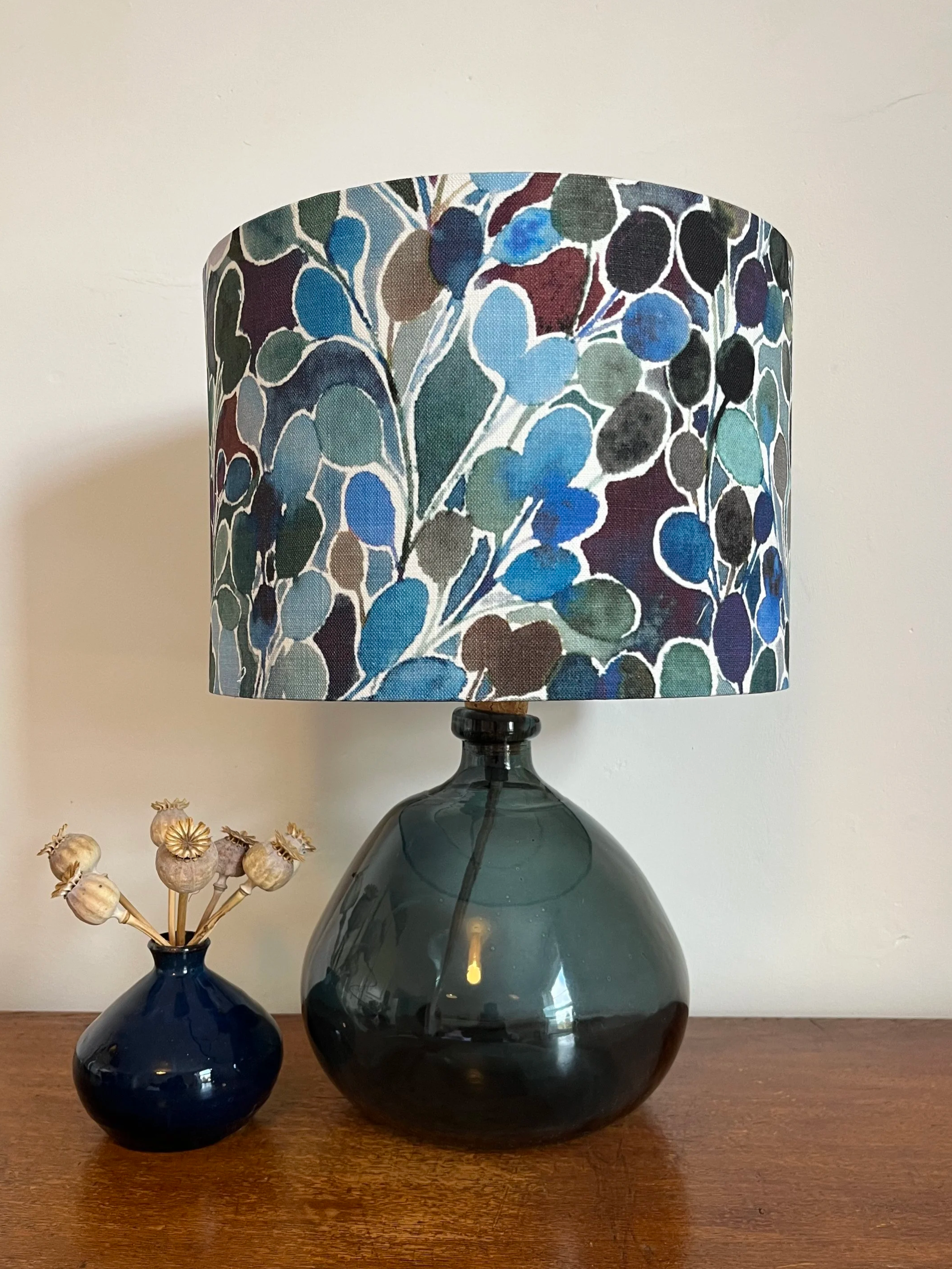 Drum lampshade with leaf design in tones of blue, green and aubergine