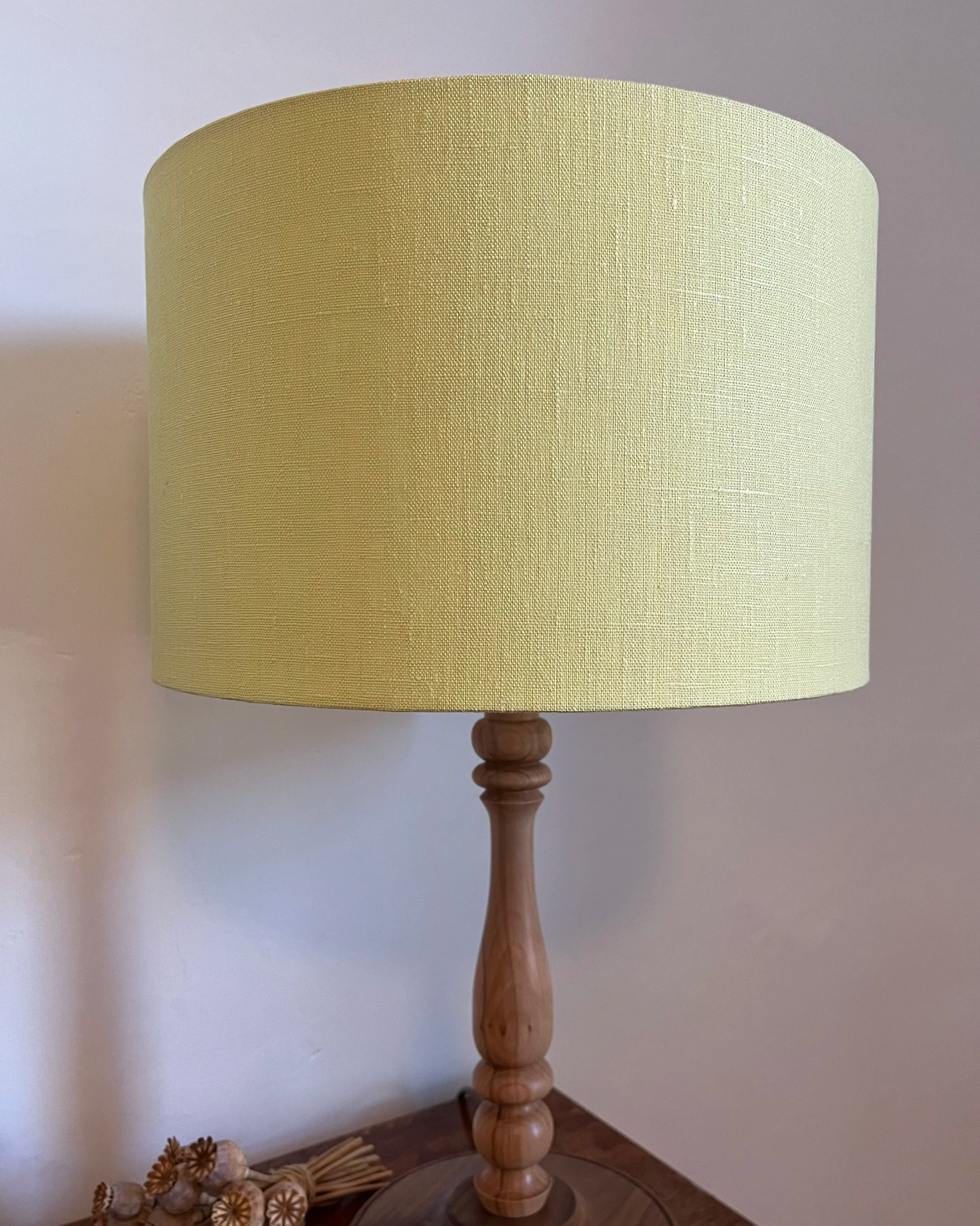 Citrus yellow drum lampshade on wooden lamp base