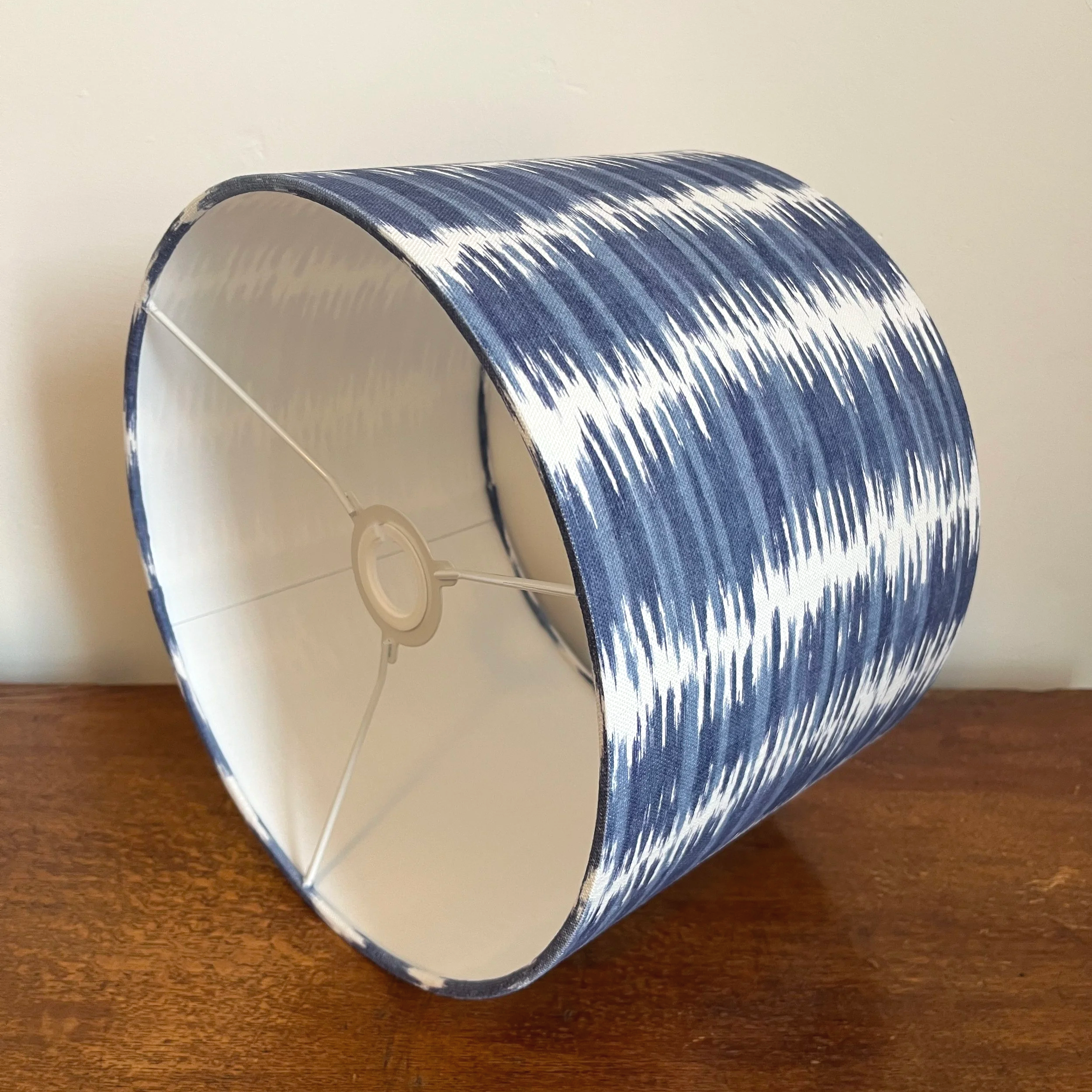 blue and white abstract stripe lampshade with white lining.