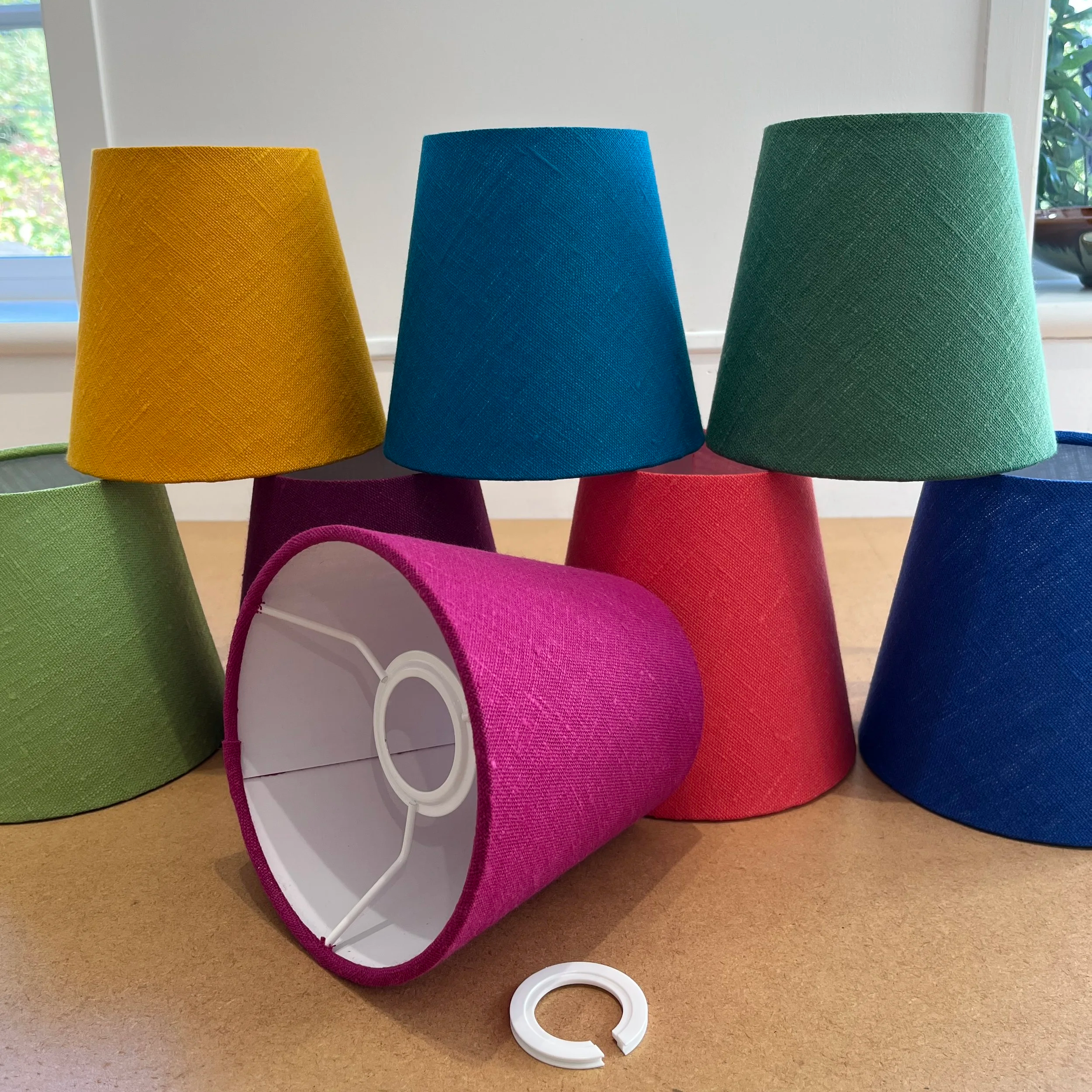 A stack of bright colour mini lamp shades