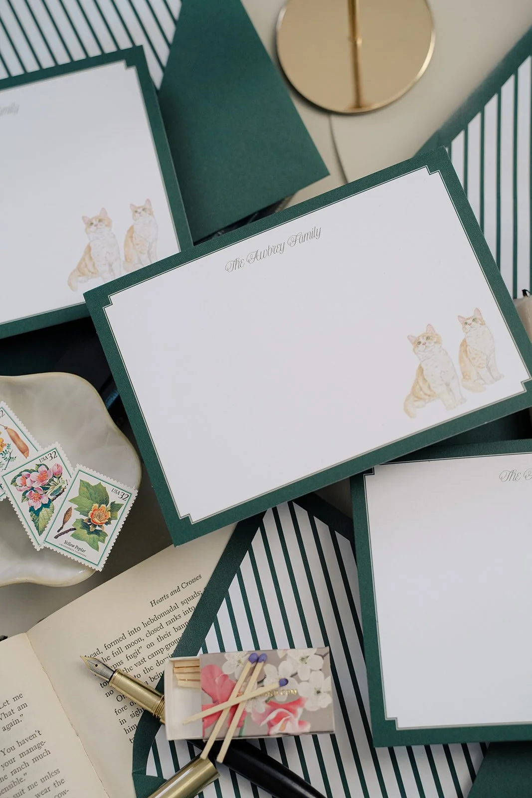 Cat stationery with dark green envelopes.