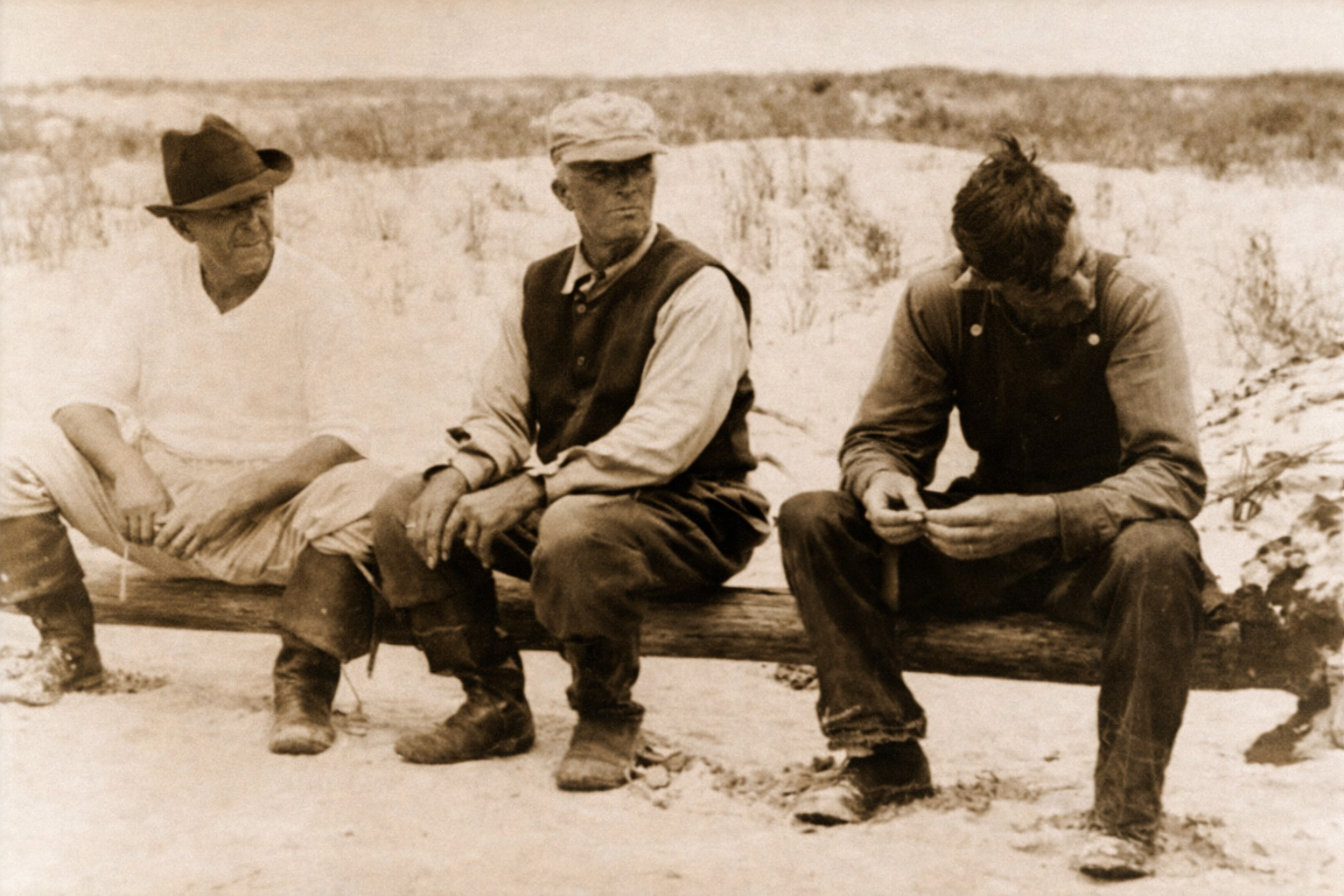 Cobb Island - Men resting on log.png