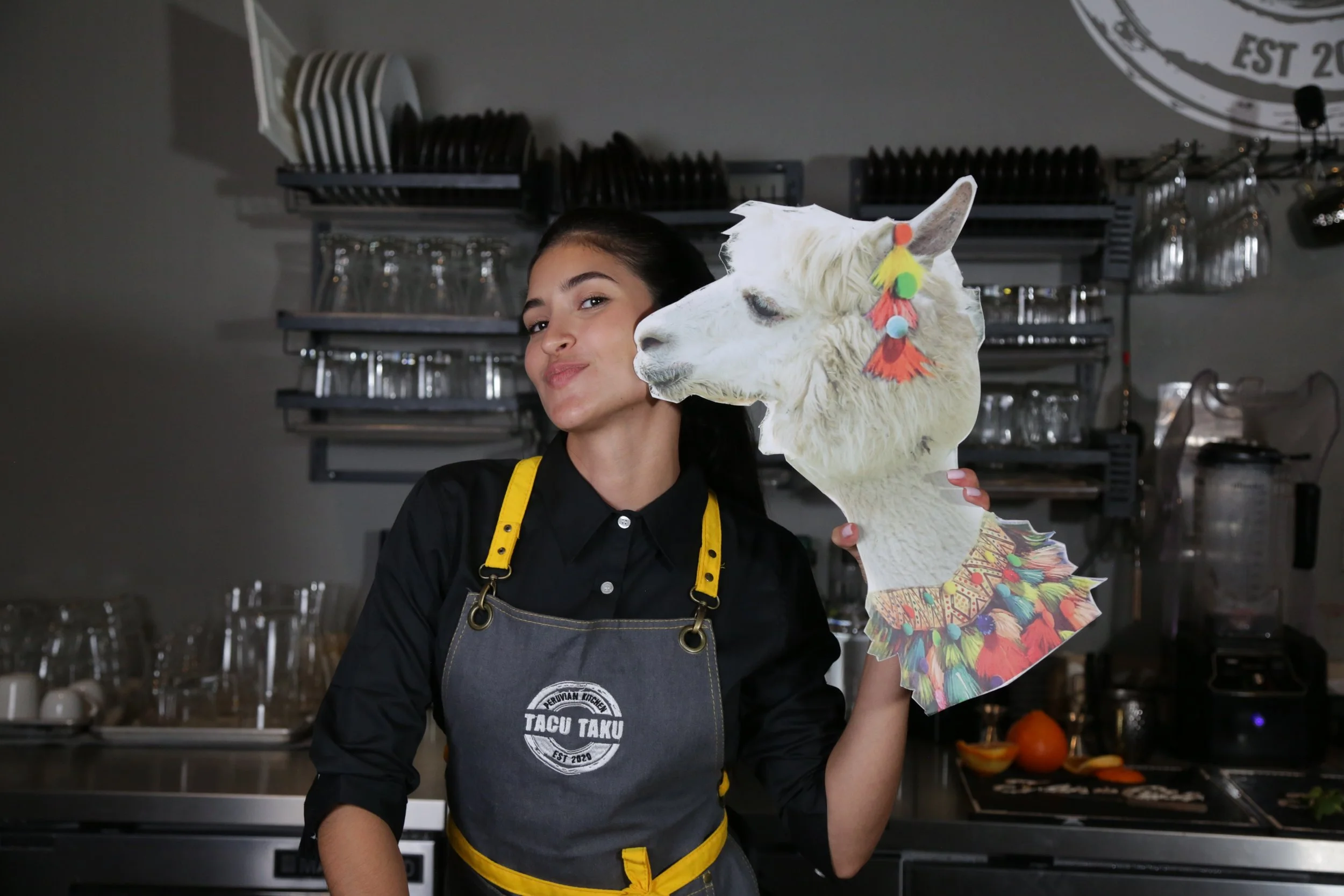 Tacu Taku team member posing with a decorated llama
